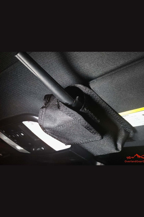 Black Sun Visor Radio Pouch attached to vehicle sun visor holding a radio device with Velcro loops for secure attachment