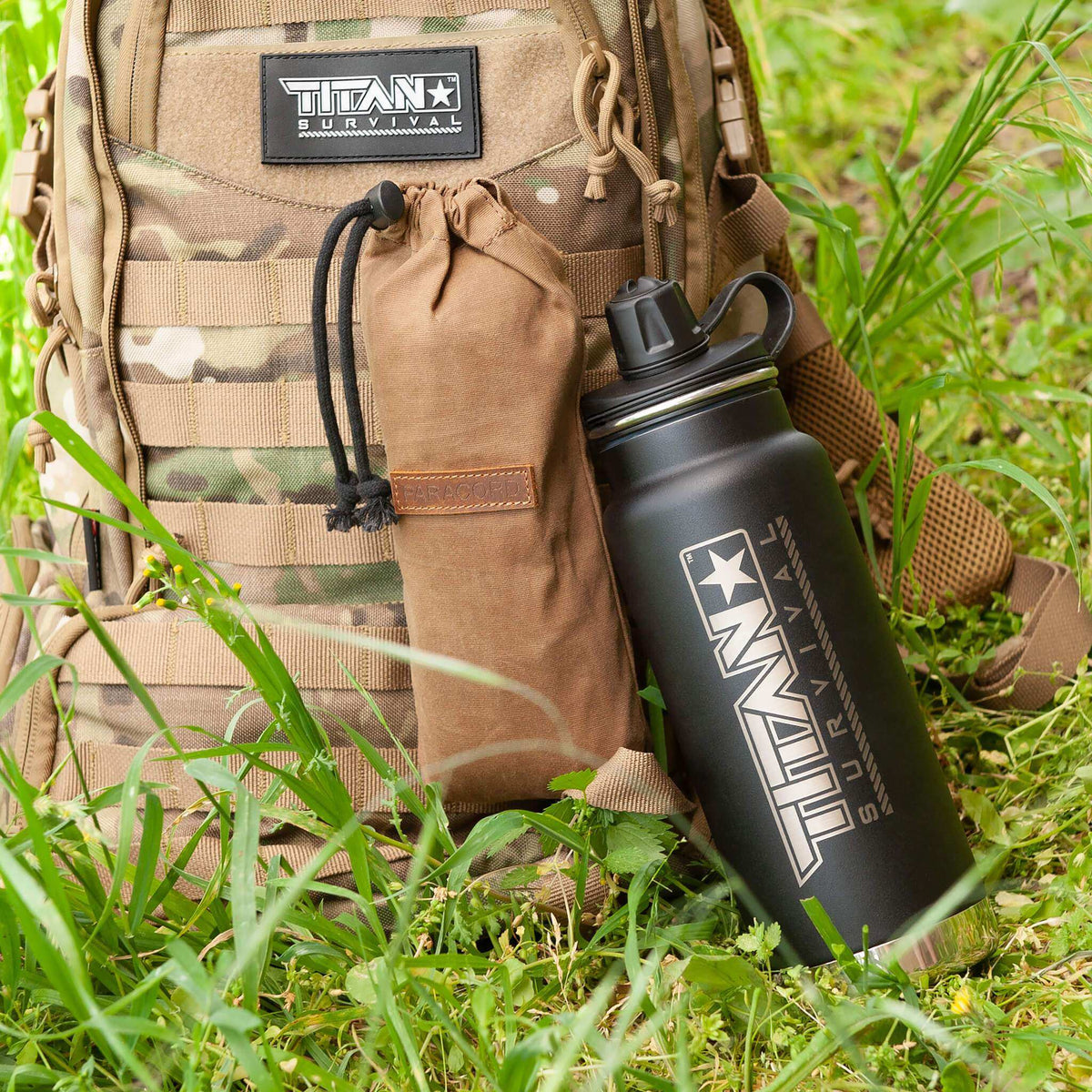 32 Oz TITAN Survival water bottle with tactical backpack, outdoors.