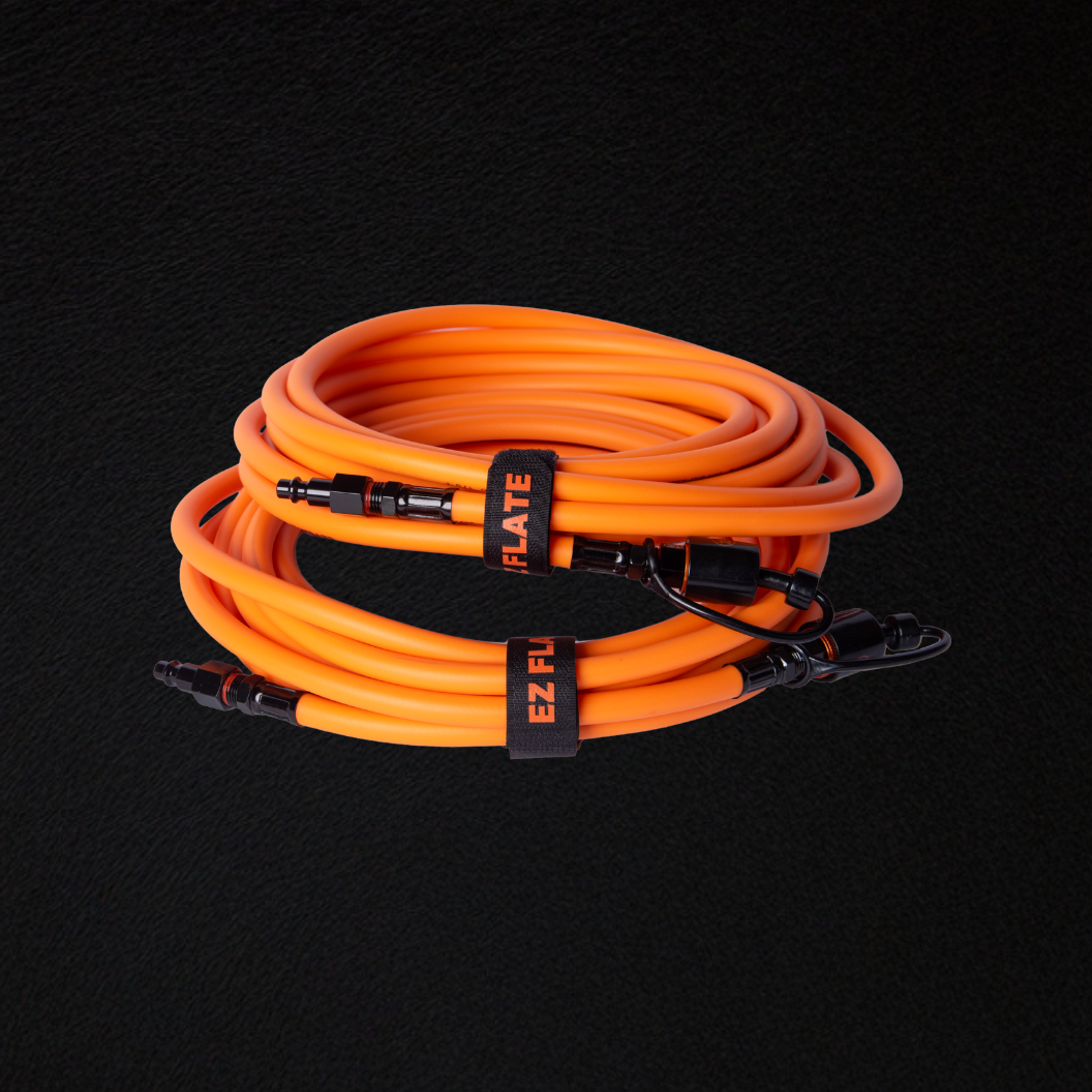 Coiled orange Hyperflex 2-way hoses with connectors and EZ Flate straps on black background