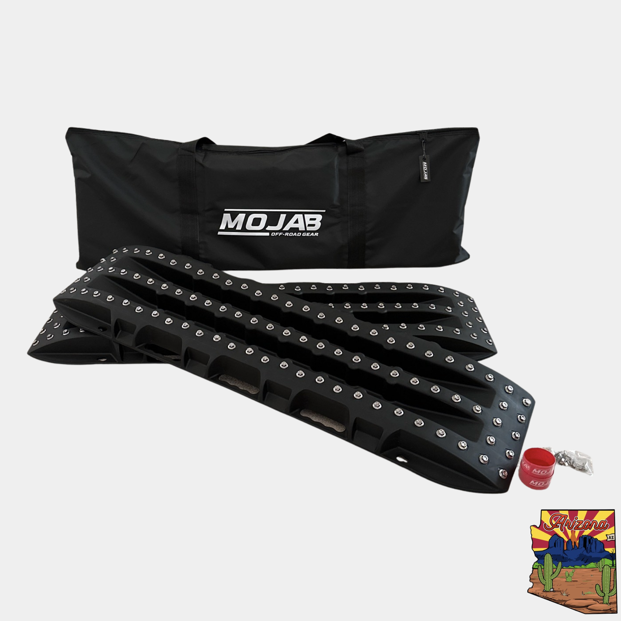 Ultimate Traction recovery board with steel plugs and storage bag for off-road vehicle traction and heavy-duty recovery.