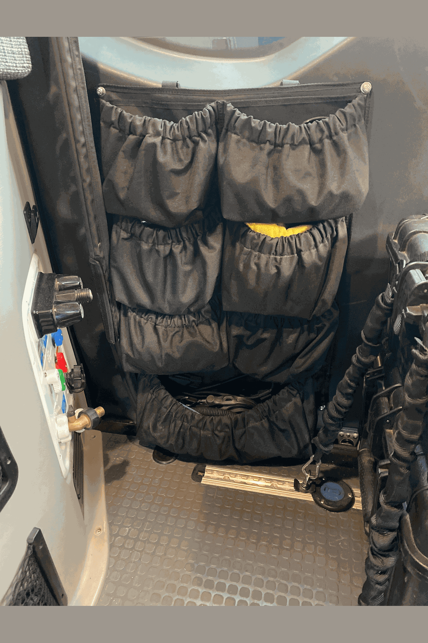 Agile Shoe Organizer mounted on vehicle rear door with multiple storage pockets for shoes and gear