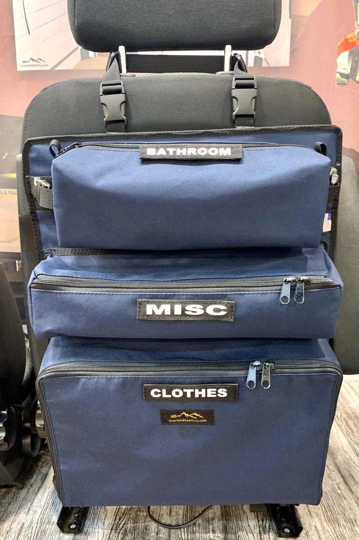 Arches Overlander 1 Seat Organizer attached to vehicle seat with labeled storage compartments for bathroom, misc, and clothes.