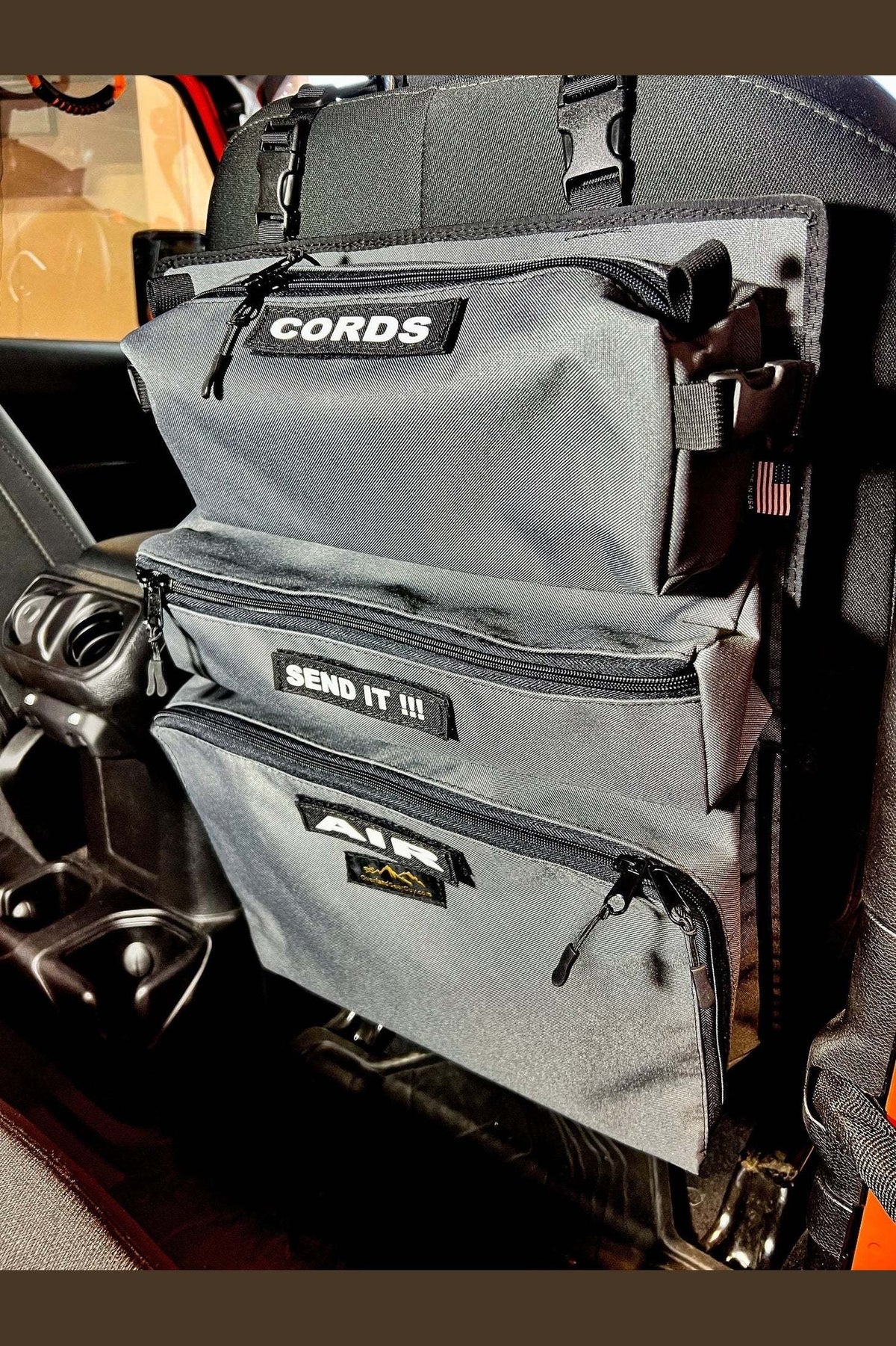 Vehicle seat with Arches Overlander 1 Seat Organizer, featuring multiple storage pockets.