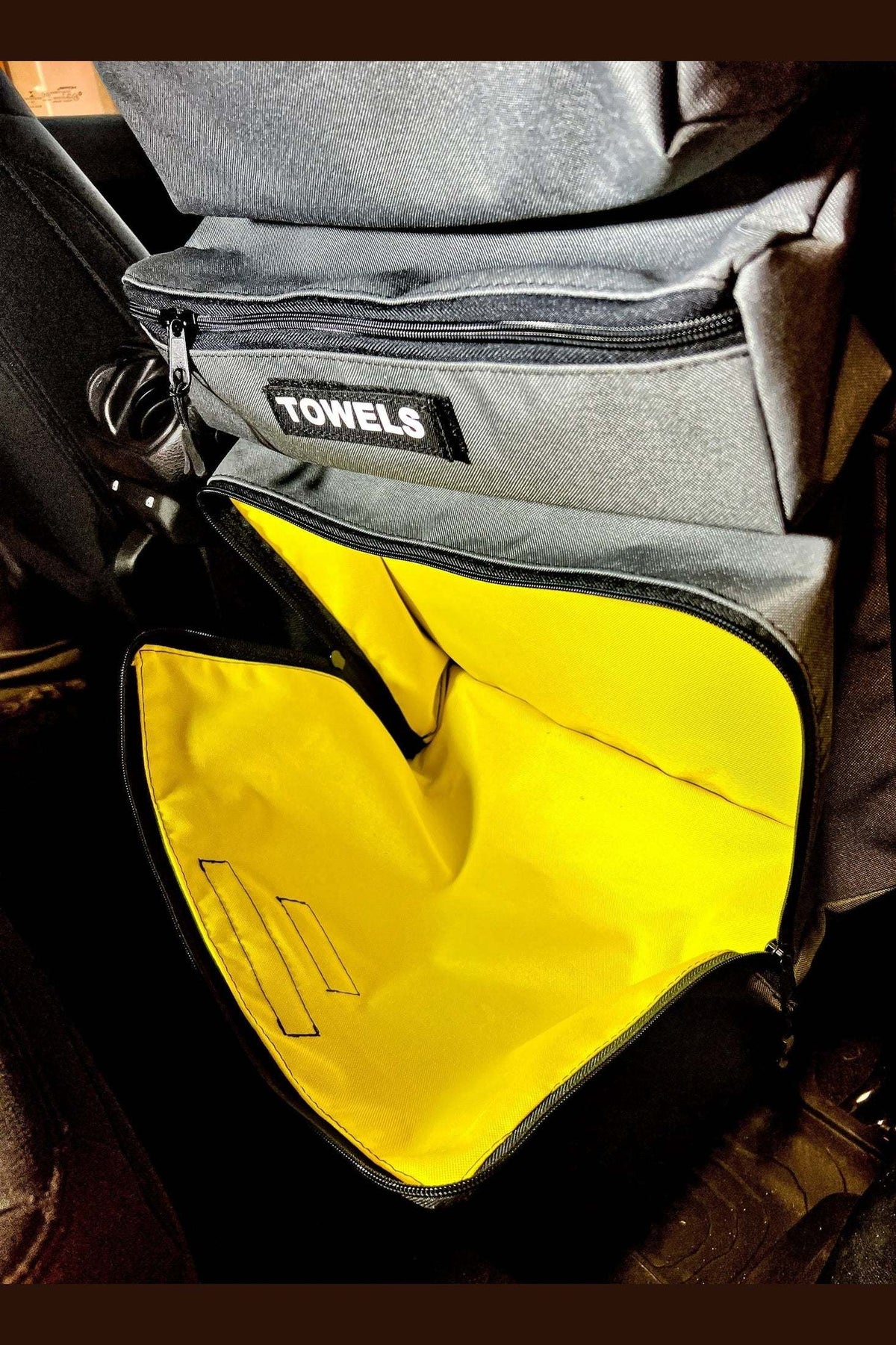 Arches Overlander 1 Seat Organizer with open yellow interior pocket, attached behind car seat.