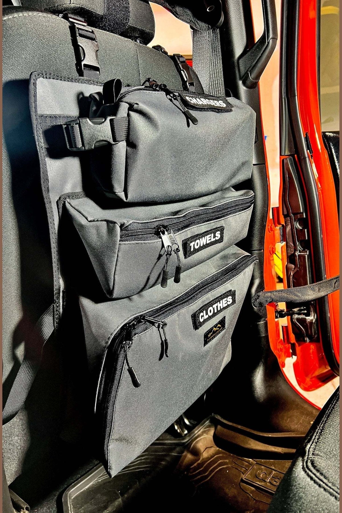 Vehicle seat with Arches Overlander 1 Seat Organizer displaying multiple storage pockets.