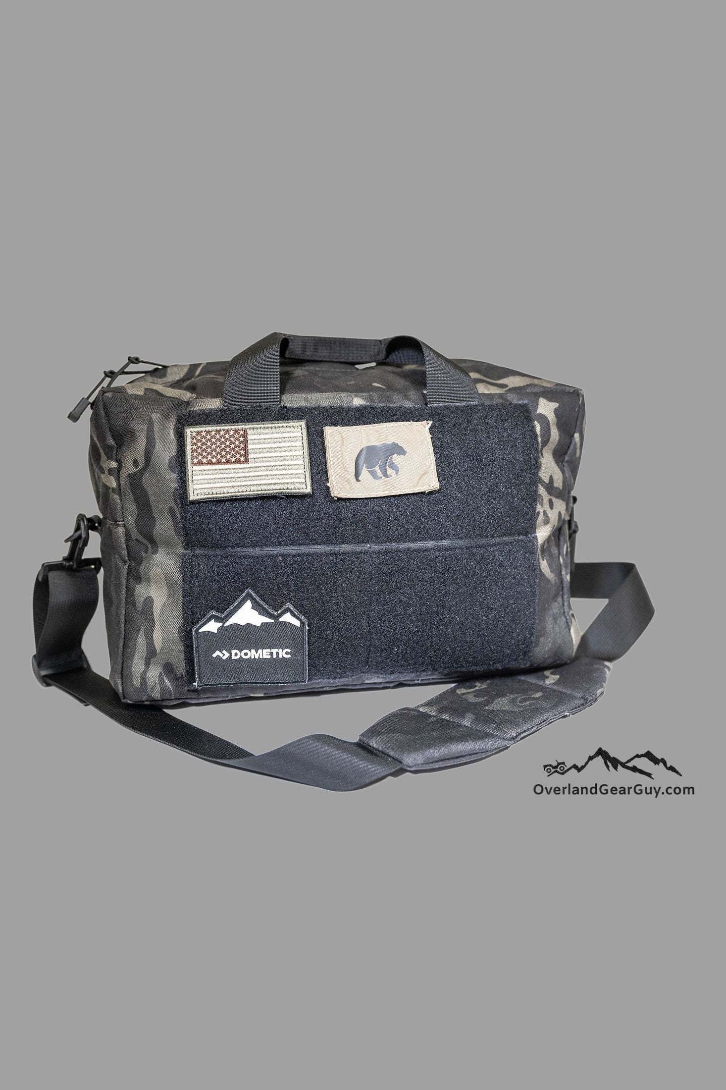 Heavy-duty Bauer Bag with MOLLE webbing, multiple pockets, padded shoulder strap, and carry handles in Black Crye Multicam.