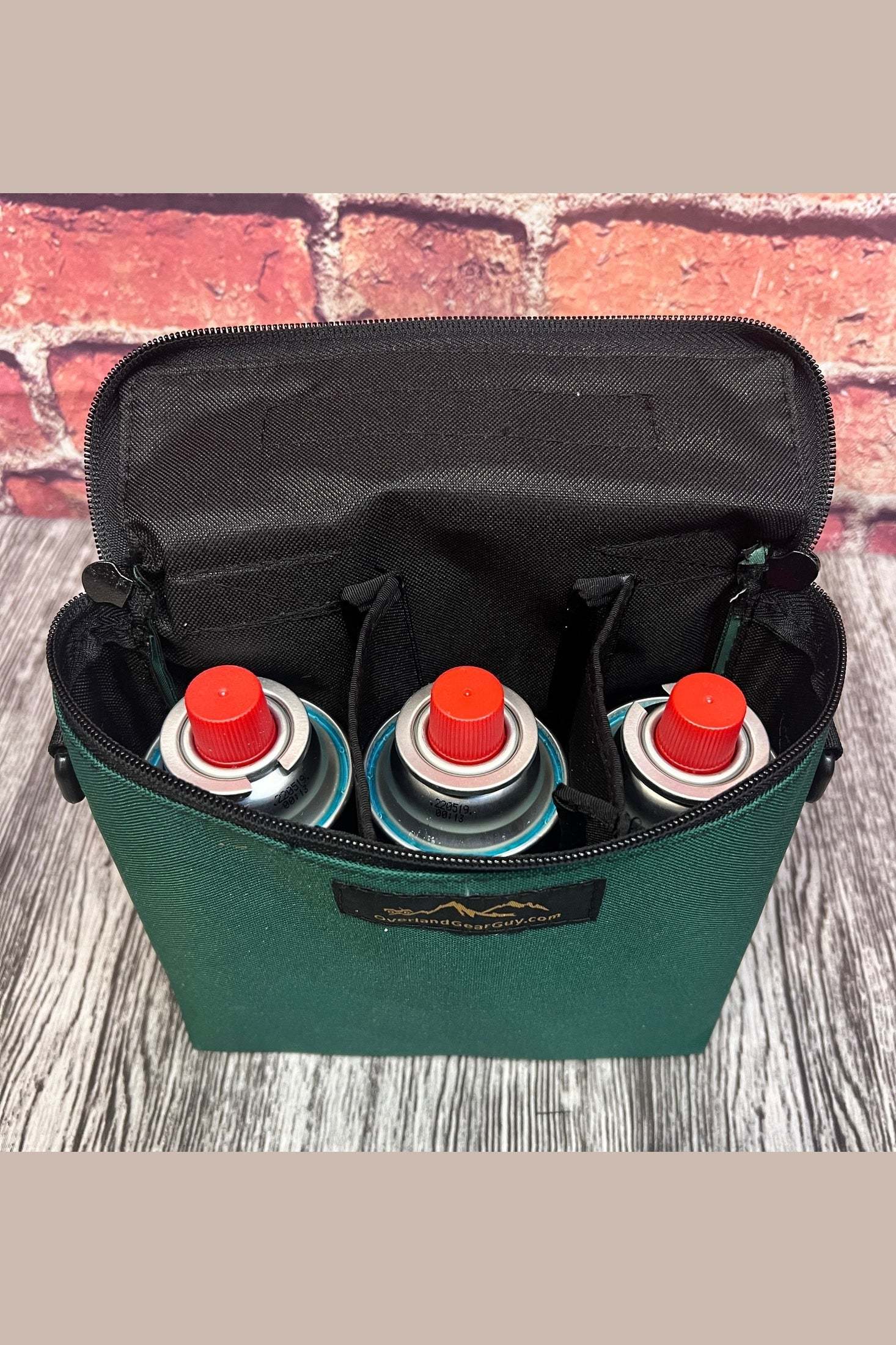 Triple Butane Can Pouch in green with three butane cans and interior fold-down flap for organized storage