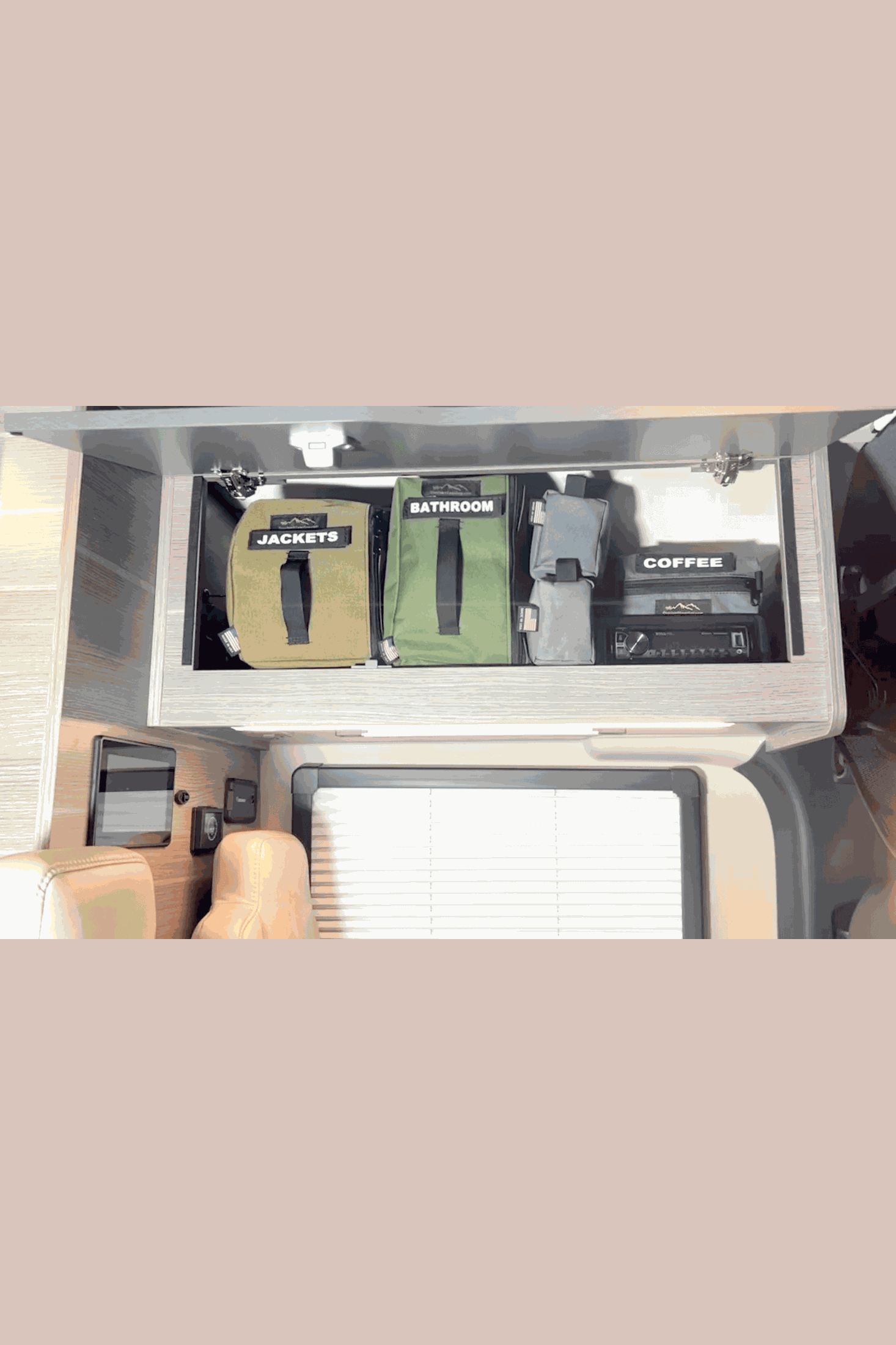 Overhead cabinet storage divider bags organizing items in van storage locker with labeled compartments