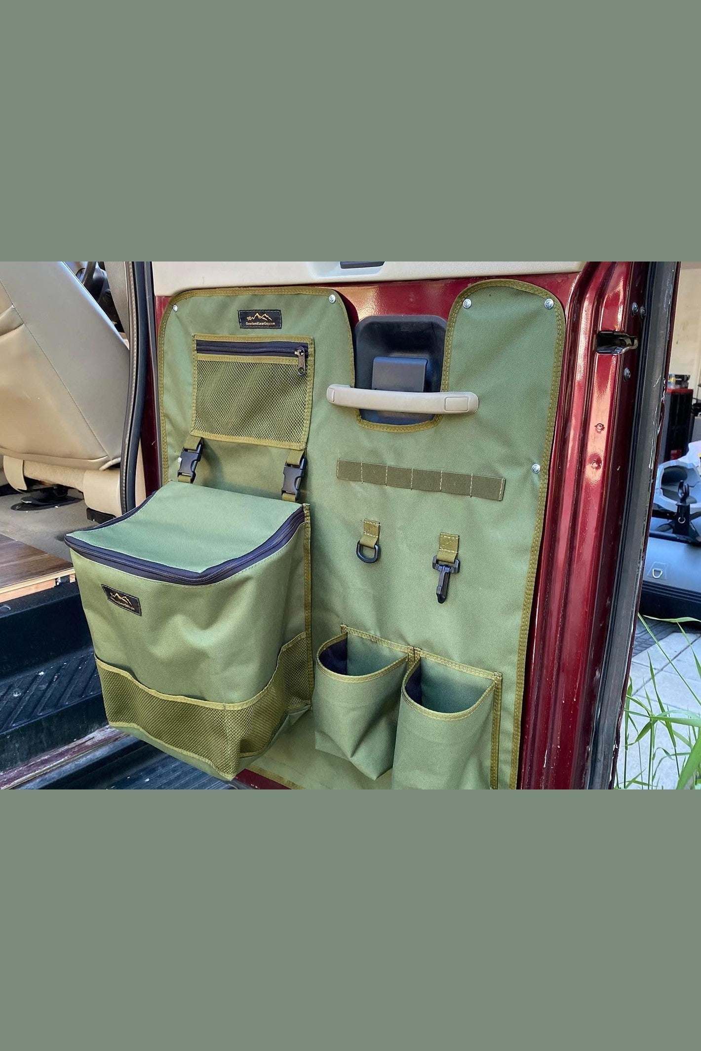 Ford Econoline barn door panel organizer with multiple storage pockets and durable green fabric hanging on van door.