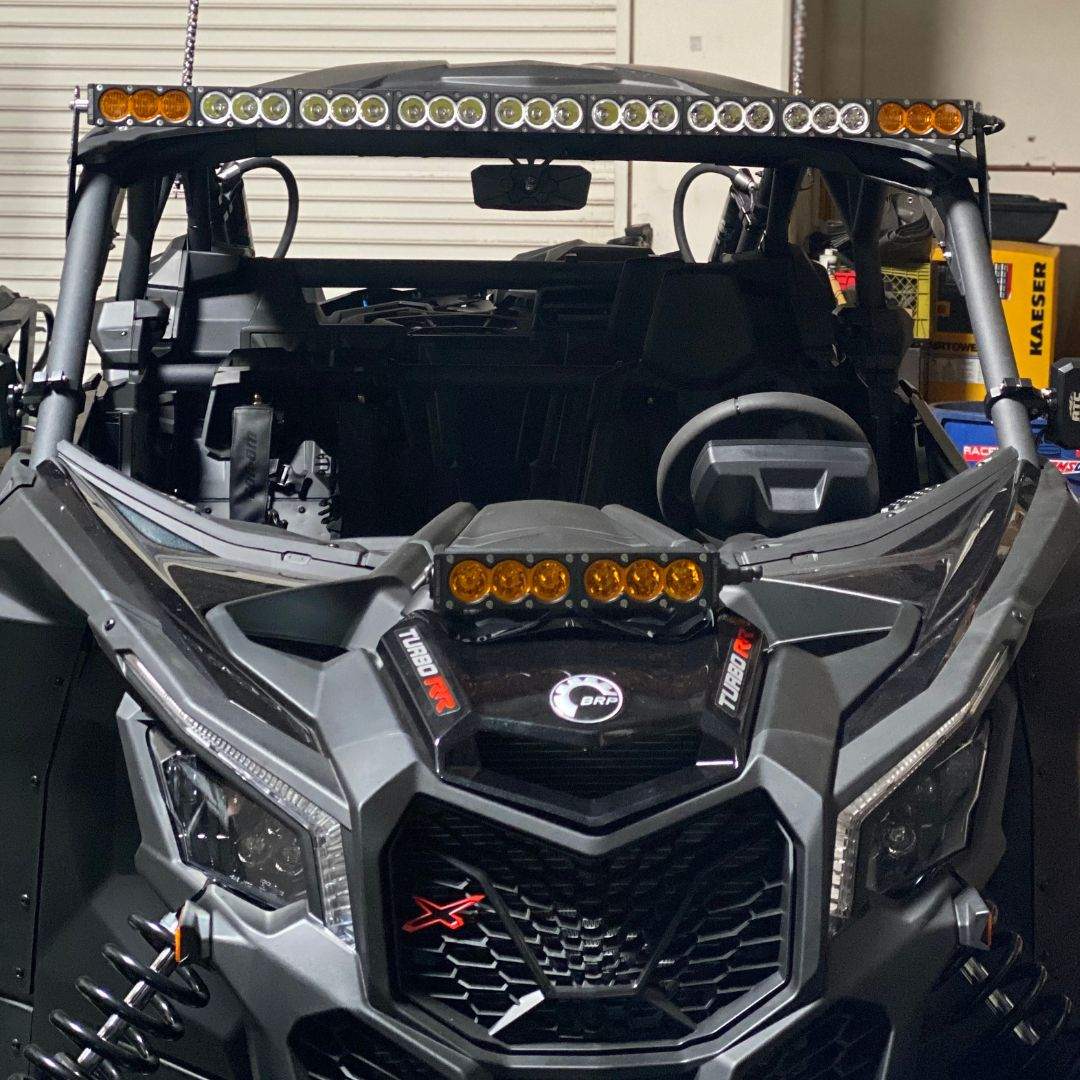 Can-Am X3 50 inch light bar bracket installed on Can-Am Maverick X3 roll cage with amber LED lights