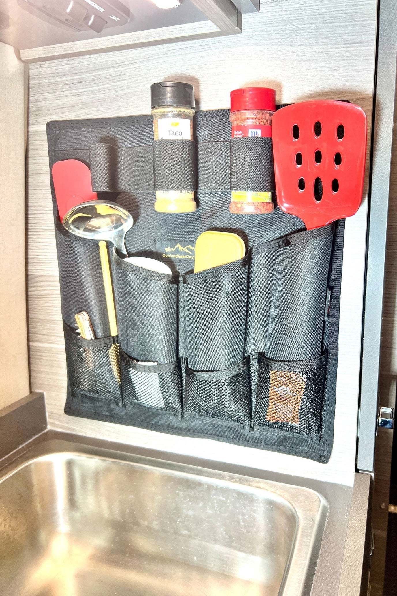 Jayco Entegra Kitchen Utensil Pouch hanging on van wall with utensils and spice jars