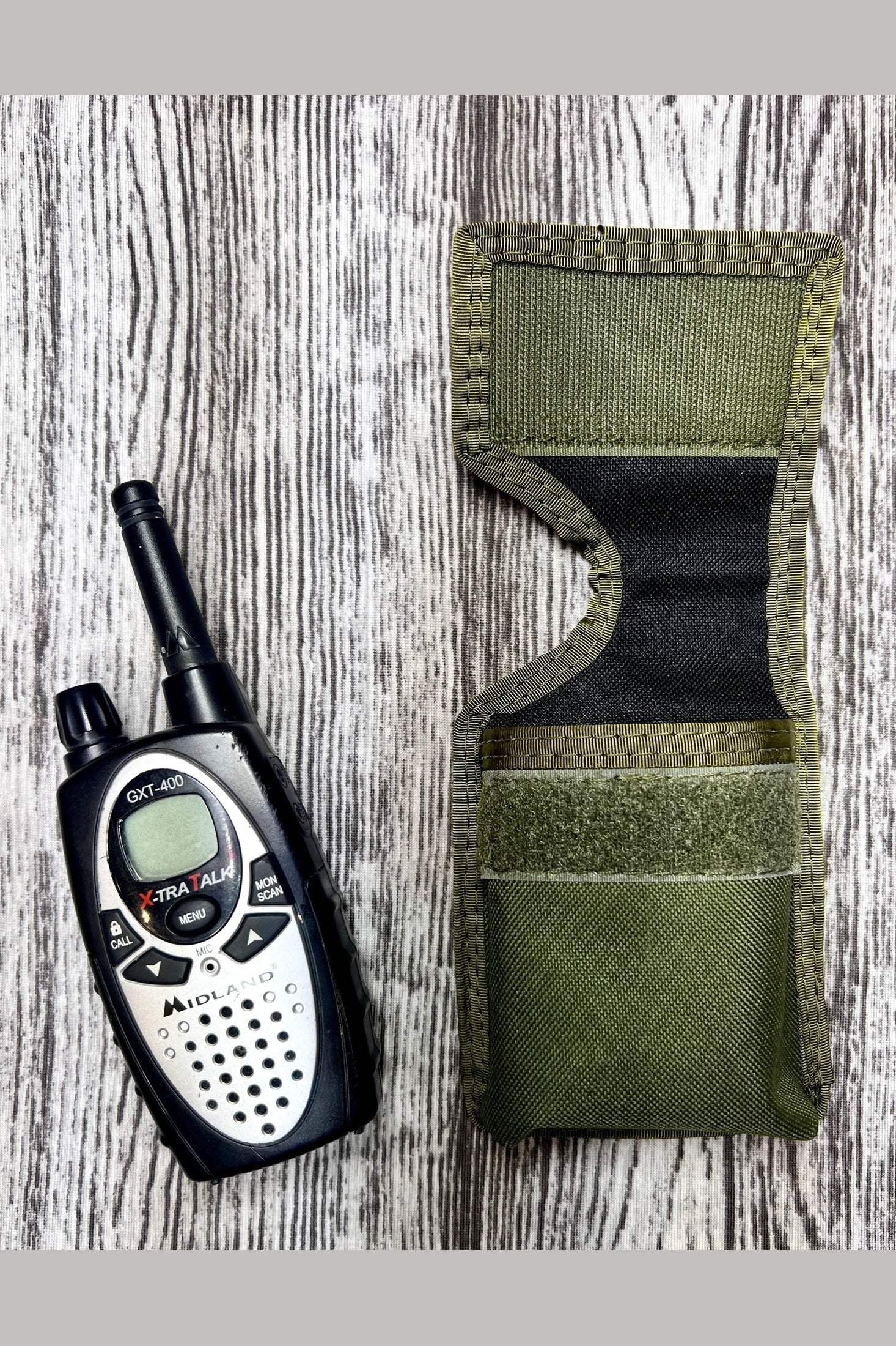 FRS radio next to green MOLLE pouch for secure gear attachment and organization
