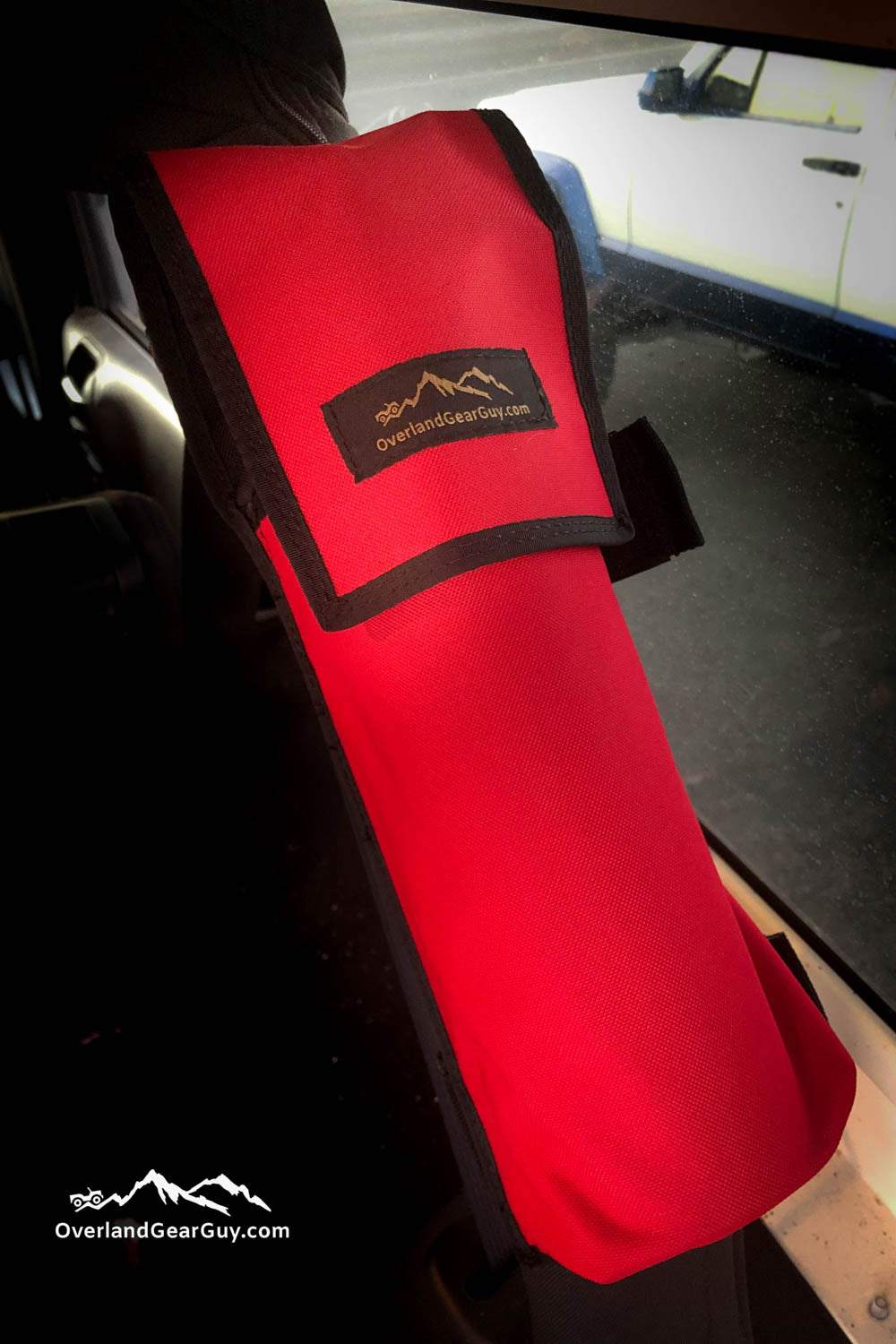 Heavy-duty red Jeep fire extinguisher pouch mounted on roll bar for secure off-road use