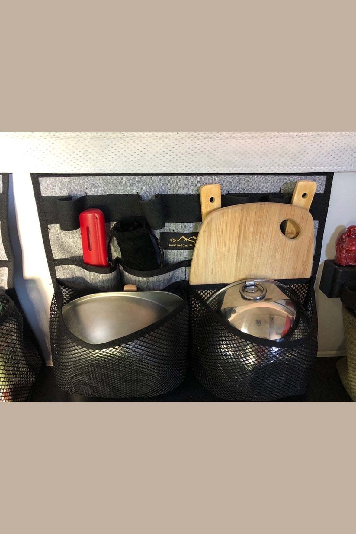 Four Wheel Camper Kitchen organizer with mesh pockets holding utensils and cutting board attached to thermal pack Velcro loop
