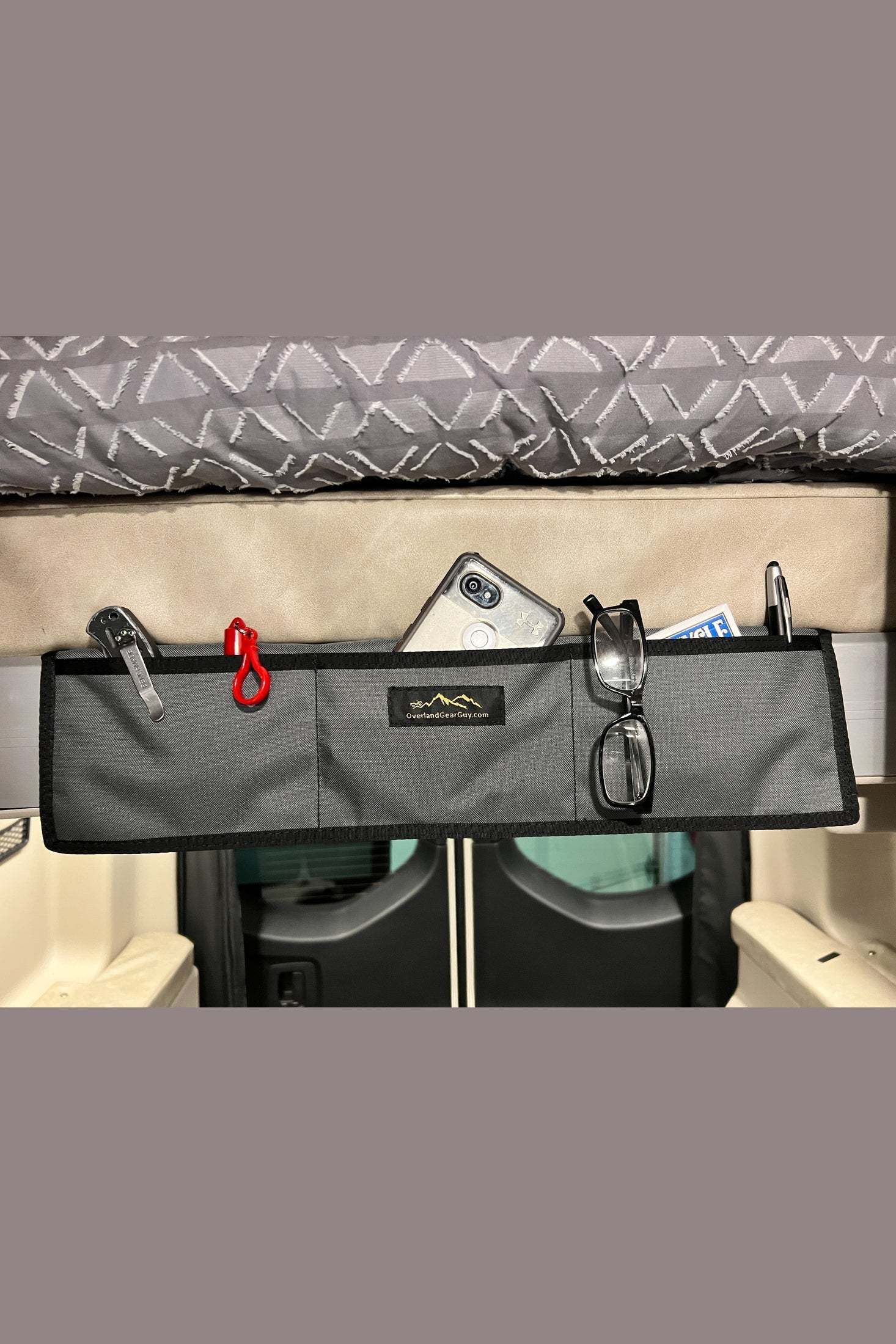 Jayco Terrain small padded bed organizer with multiple pockets for glasses, phone, and small items in van interior