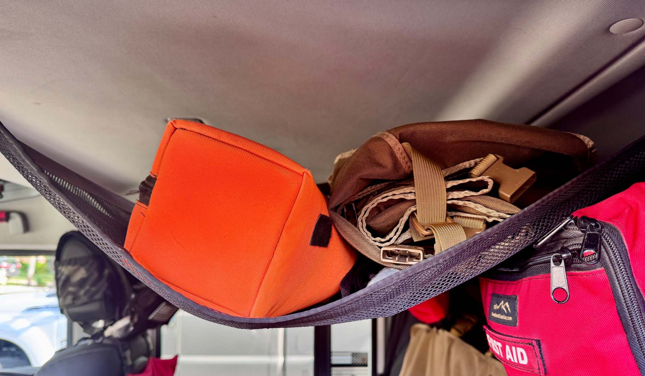 Grenadier Ceiling Hammock heavy-duty overhead storage with orange and red gear inside vehicle interior