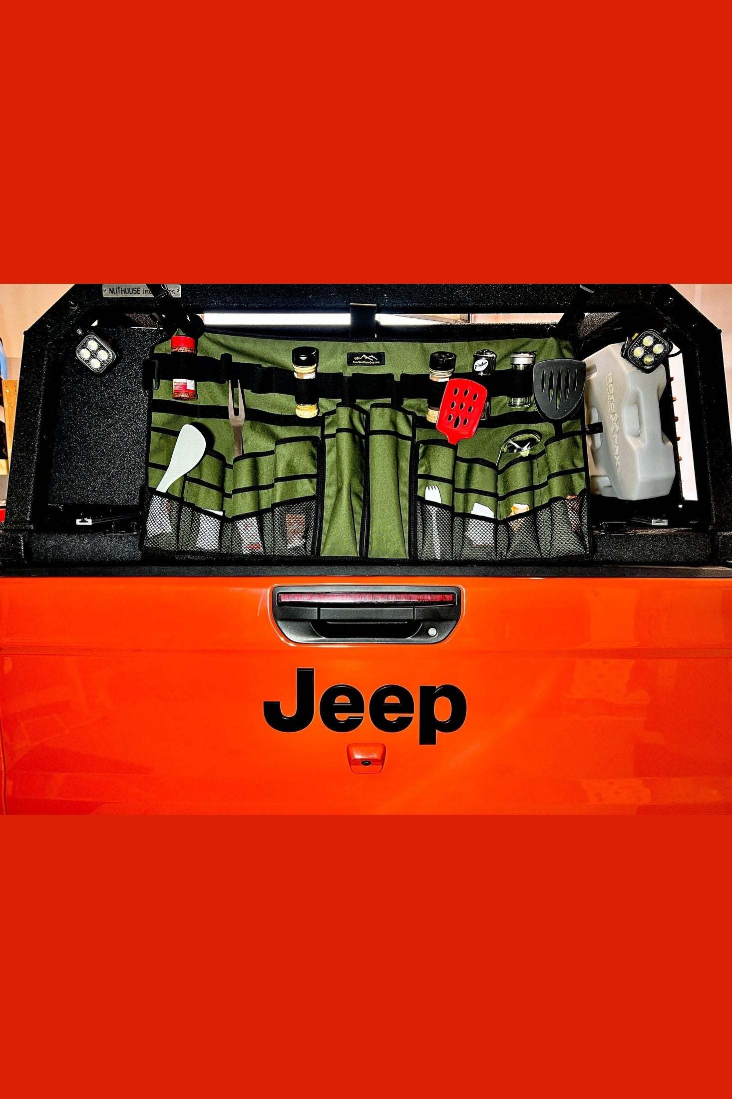 Top Chef Utensil Organizer mounted on Jeep tailgate with utensils and camping gear neatly stored in green pockets and loops
