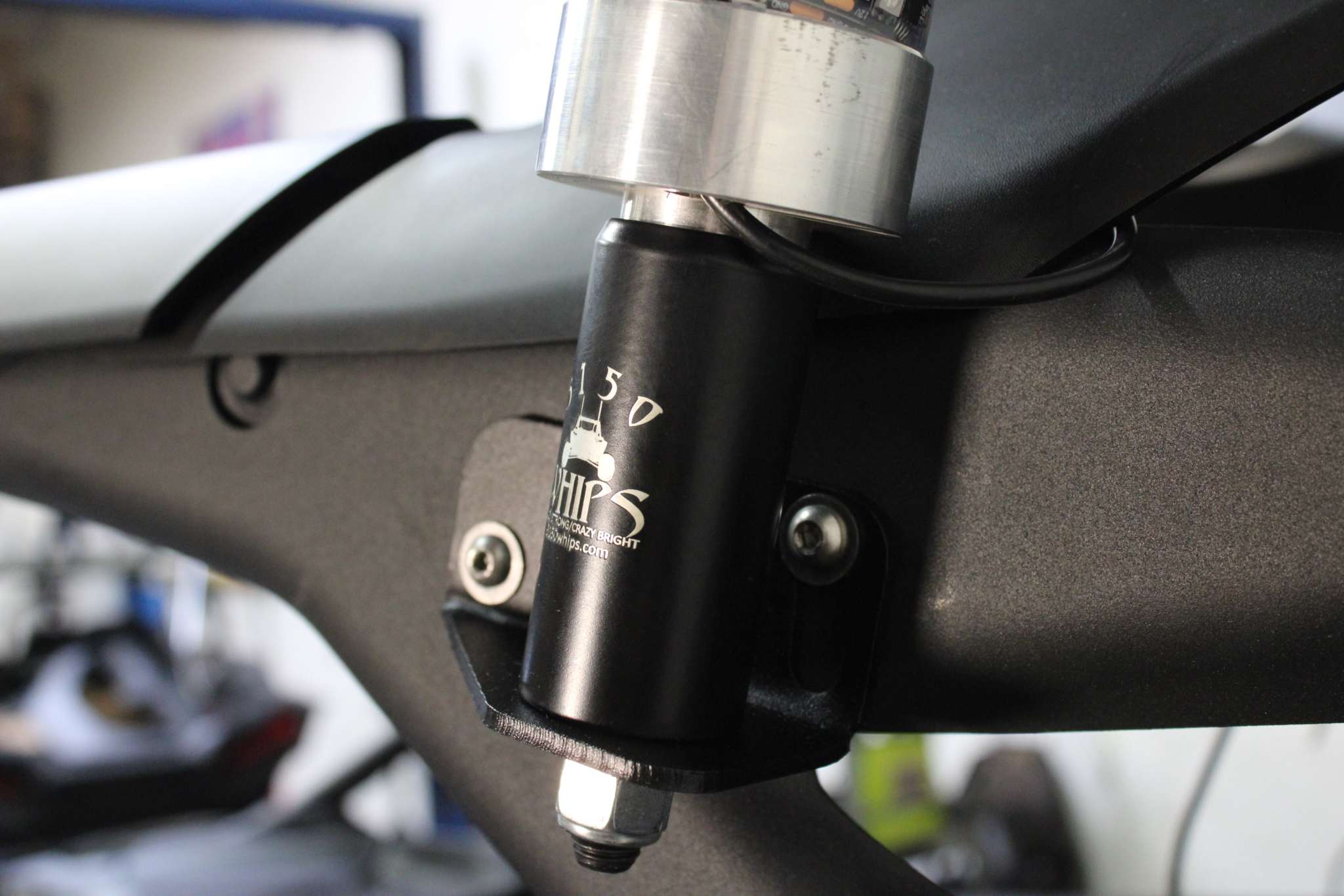 Can-Am Maverick R whip mount made of 3/16 gauge steel with heavy-duty powder coat installed on roll bar using stock bolts