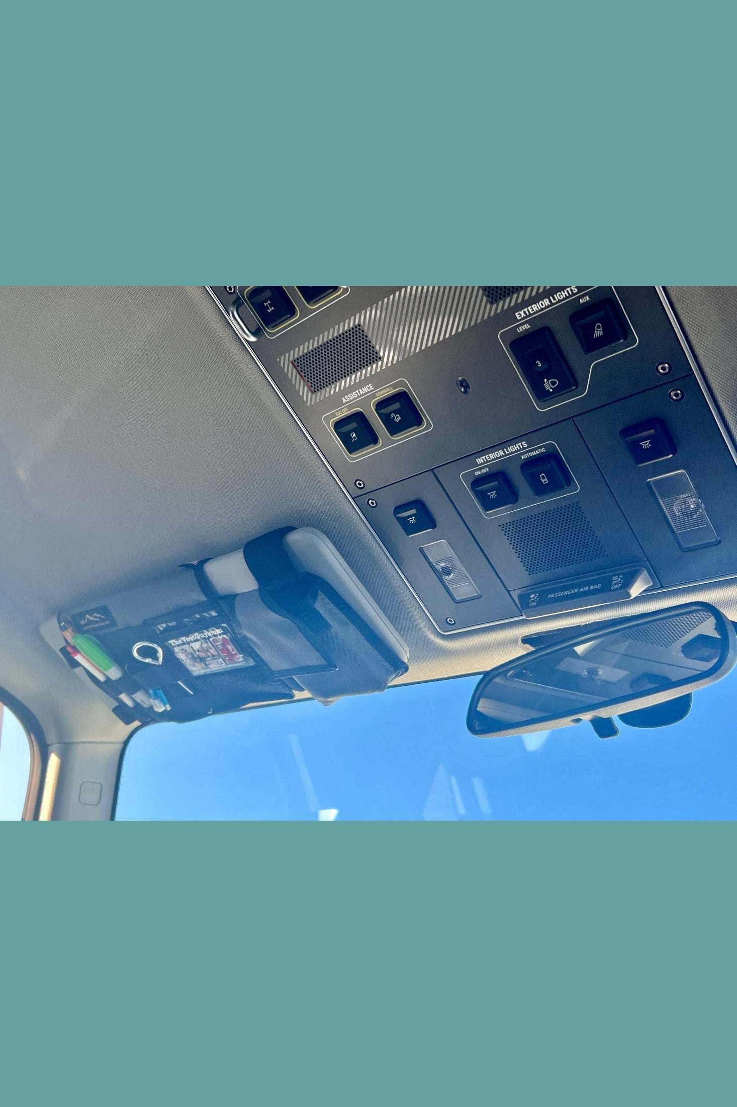 INEOS Grenadier MOLLE visor organizer attached to sun visor with multiple compartments for storage