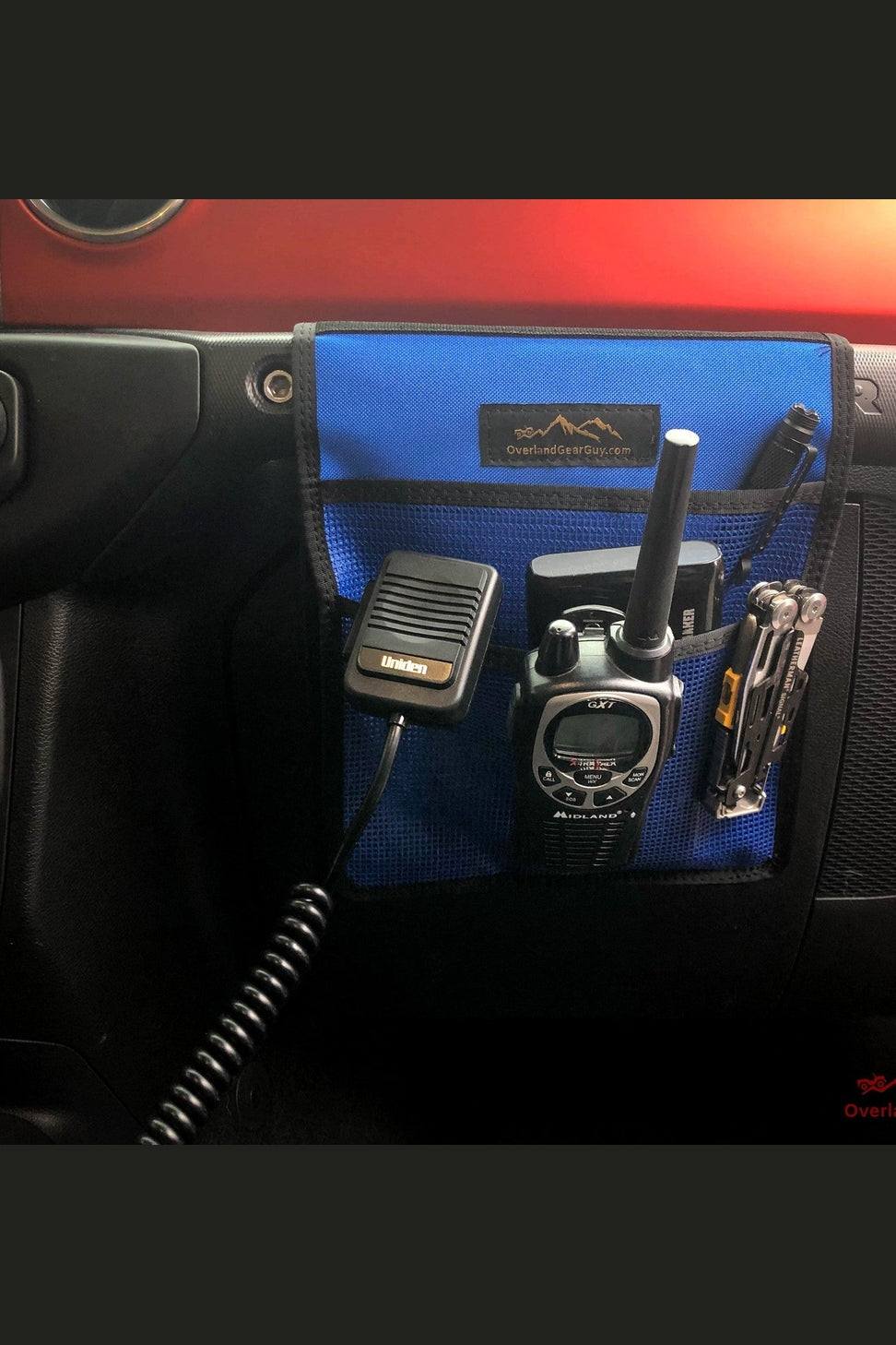 Blue Jeep grab handle mesh pocket attached to interior grab handle holding radio, mic, and multi-tool
