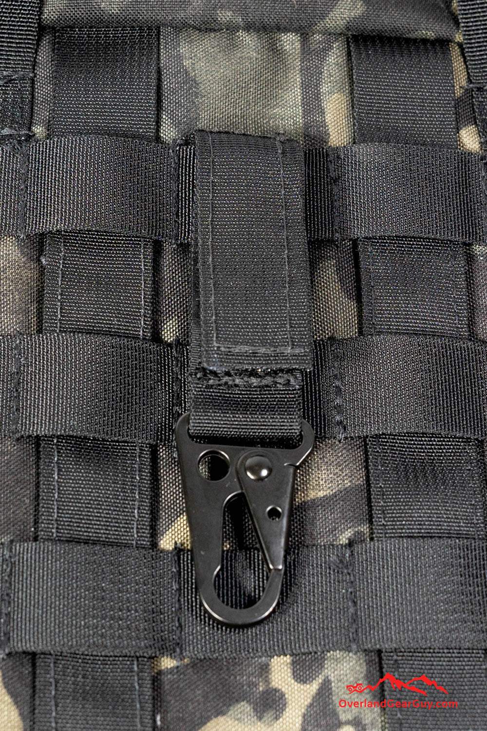 1 inch black HK Clip Hook with Velcro attached to MOLLE webbing on camo gear