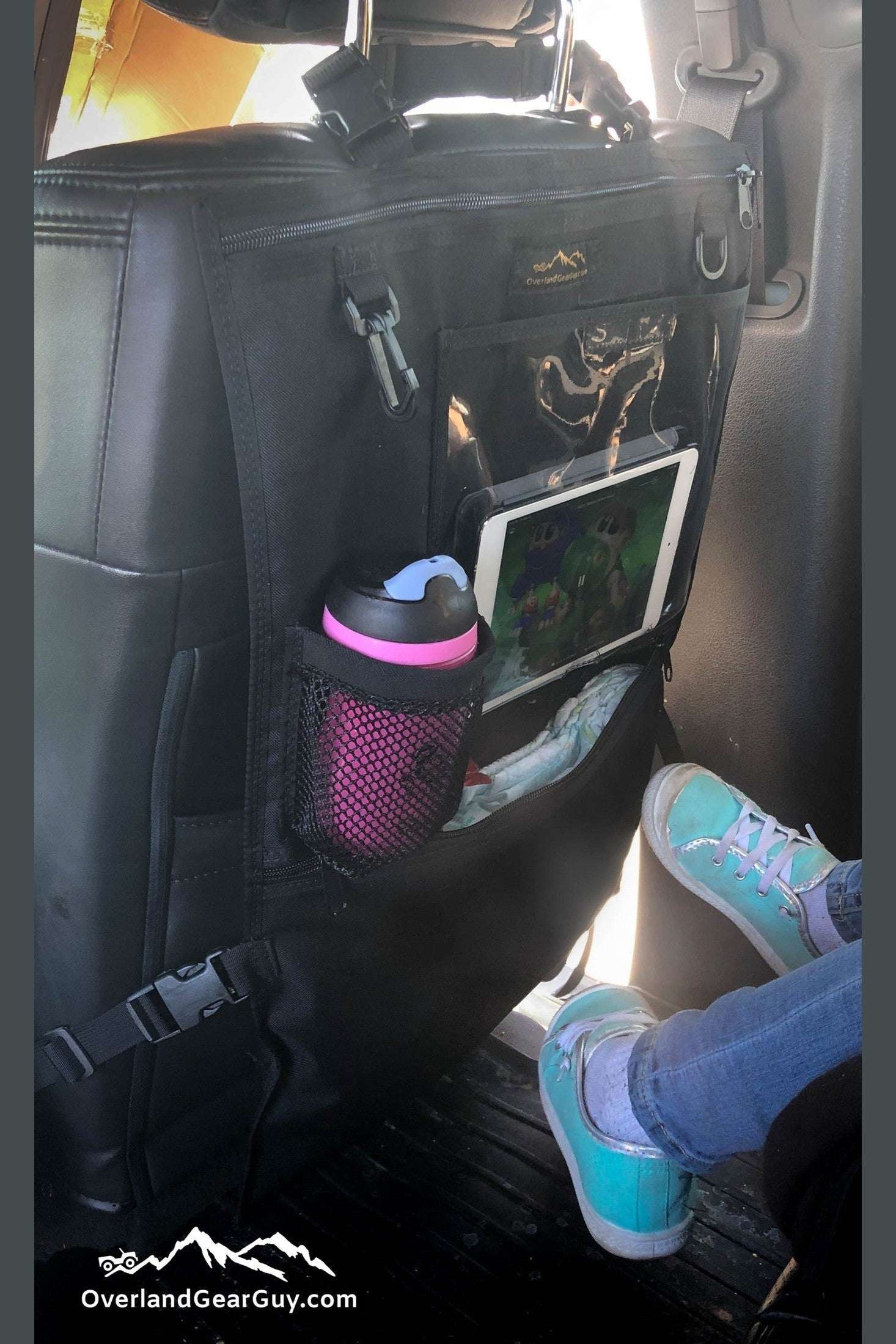 Kid Caddy Seat Organizer attached to car seat with tablet, cup holder, and storage pockets