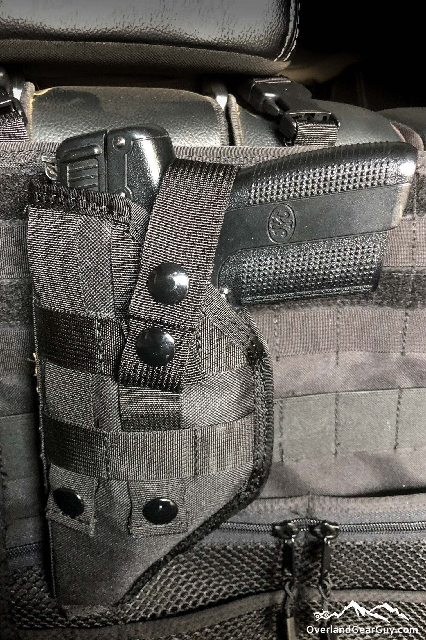 Durable MOLLE gun holster with secure fit and ambidextrous design attached to tactical gear