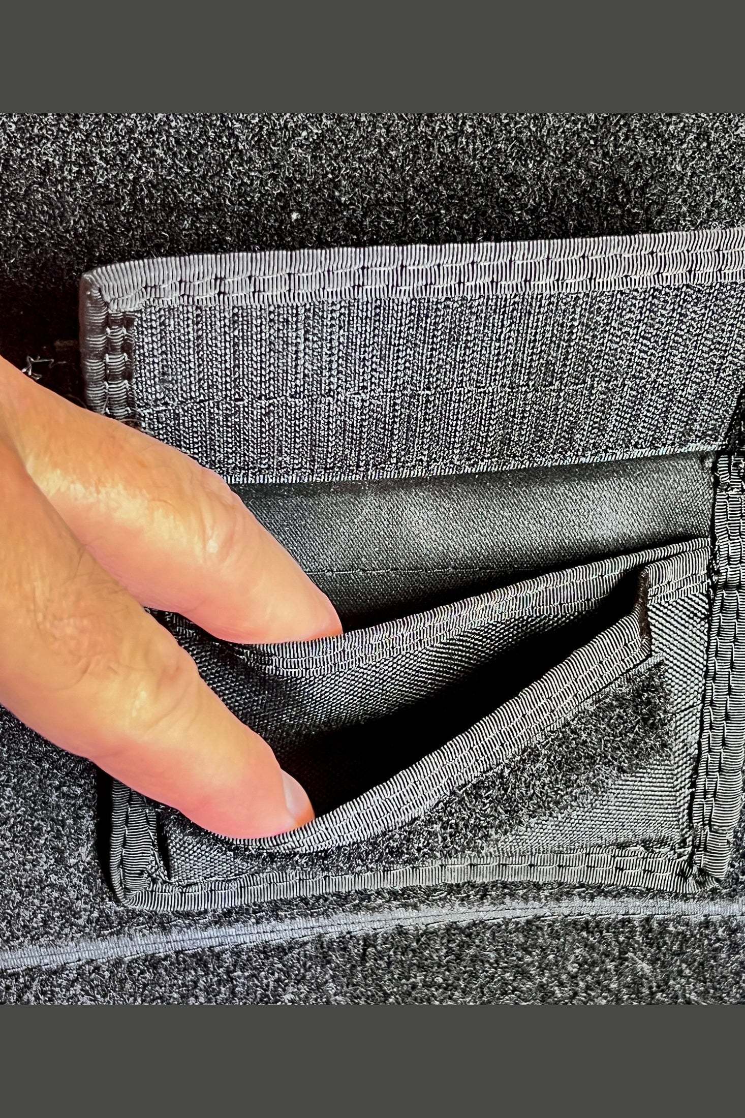 Close-up of 3x5 modular velcro pocket attached to a fabric surface, showing durable stitching and pocket opening