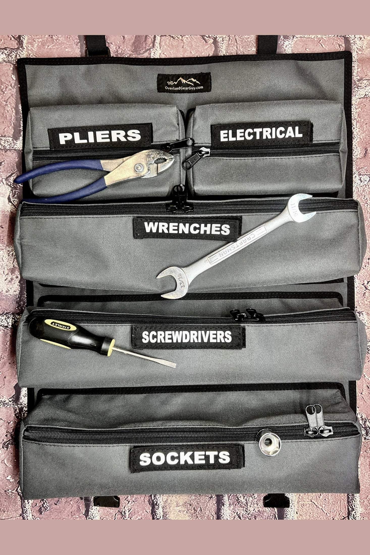 OGG Tool Roll with labeled compartments for pliers, electrical, wrenches, screwdrivers, and sockets showing organized tools