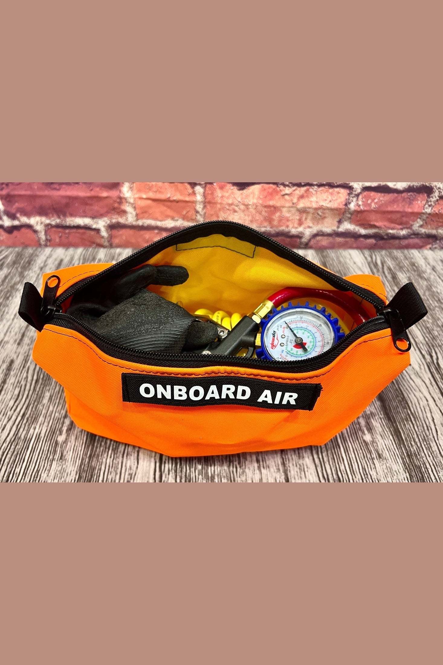 Orange OnBoard Air bag with air tool accessories inside for organized storage and protection