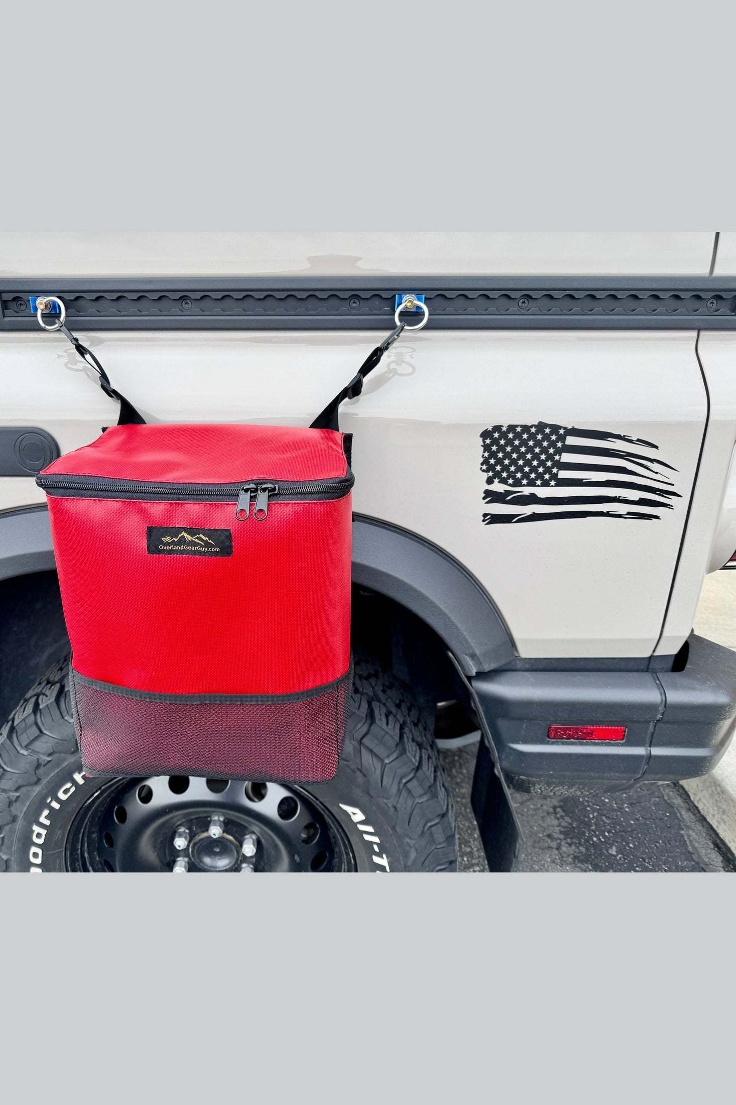 Red heavy-duty outside trash bag mounted on vehicle L-Track with optional suction cups for outdoor use