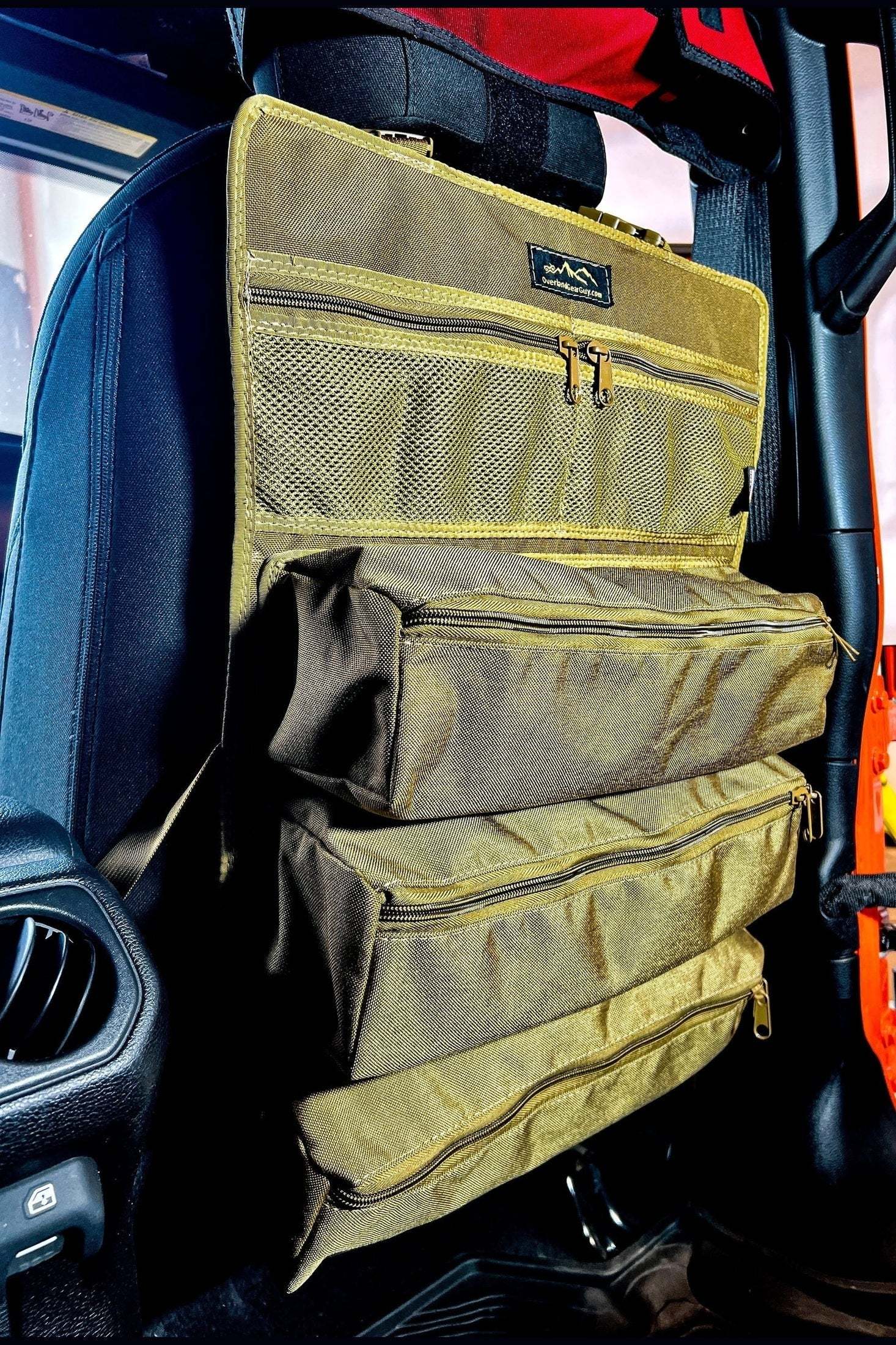 Poplar Seat Organizer hanging on car seat with multiple zippered storage compartments