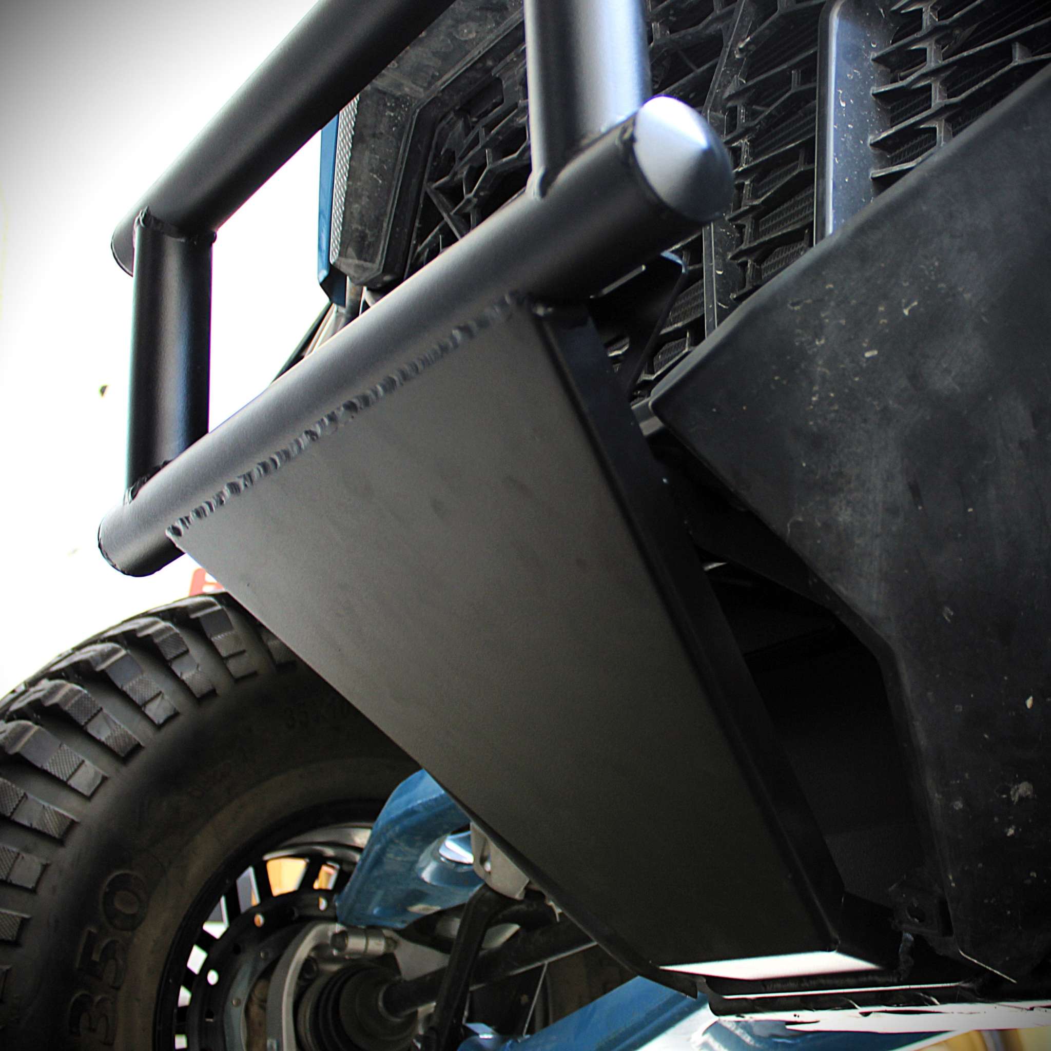 Close-up of ATC steel front bumper installed on Polaris RZR Pro R off-road vehicle