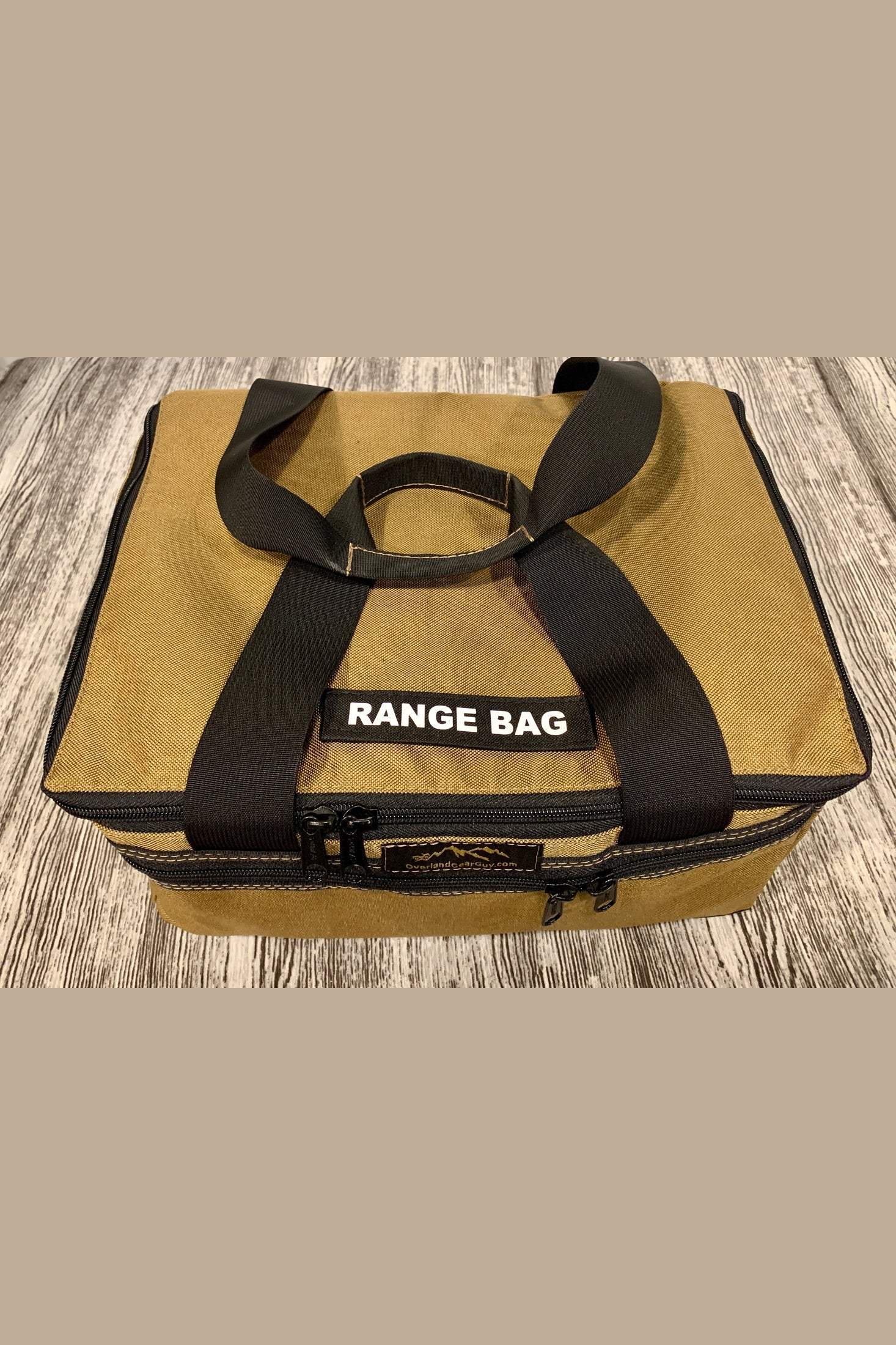 Durable tan Range Bag - Ammo Bag with black handles and multiple compartments for organizing shooting gear.