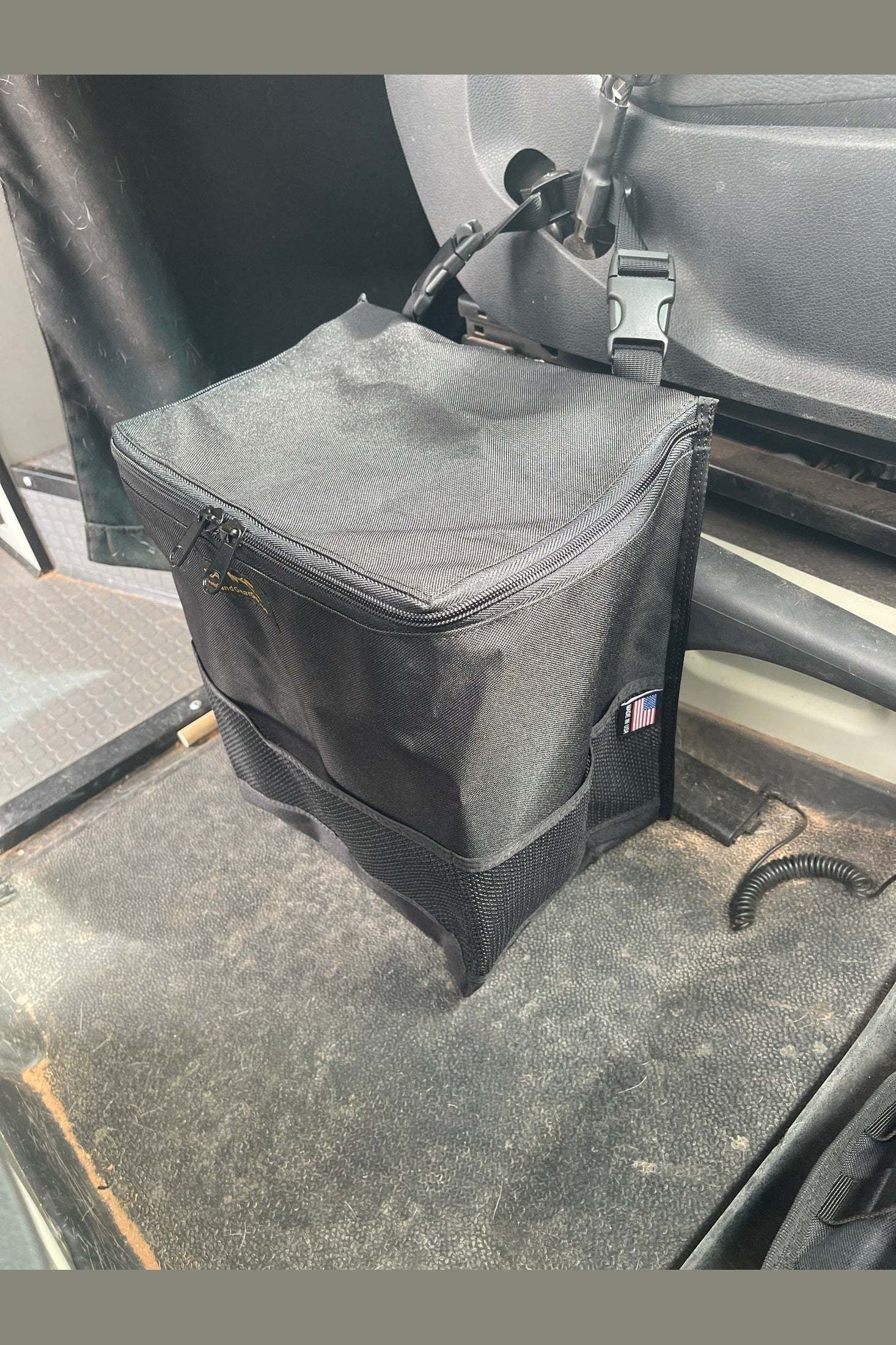 Revel Van Trash Bag medium size installed between seats for convenient in-vehicle trash storage
