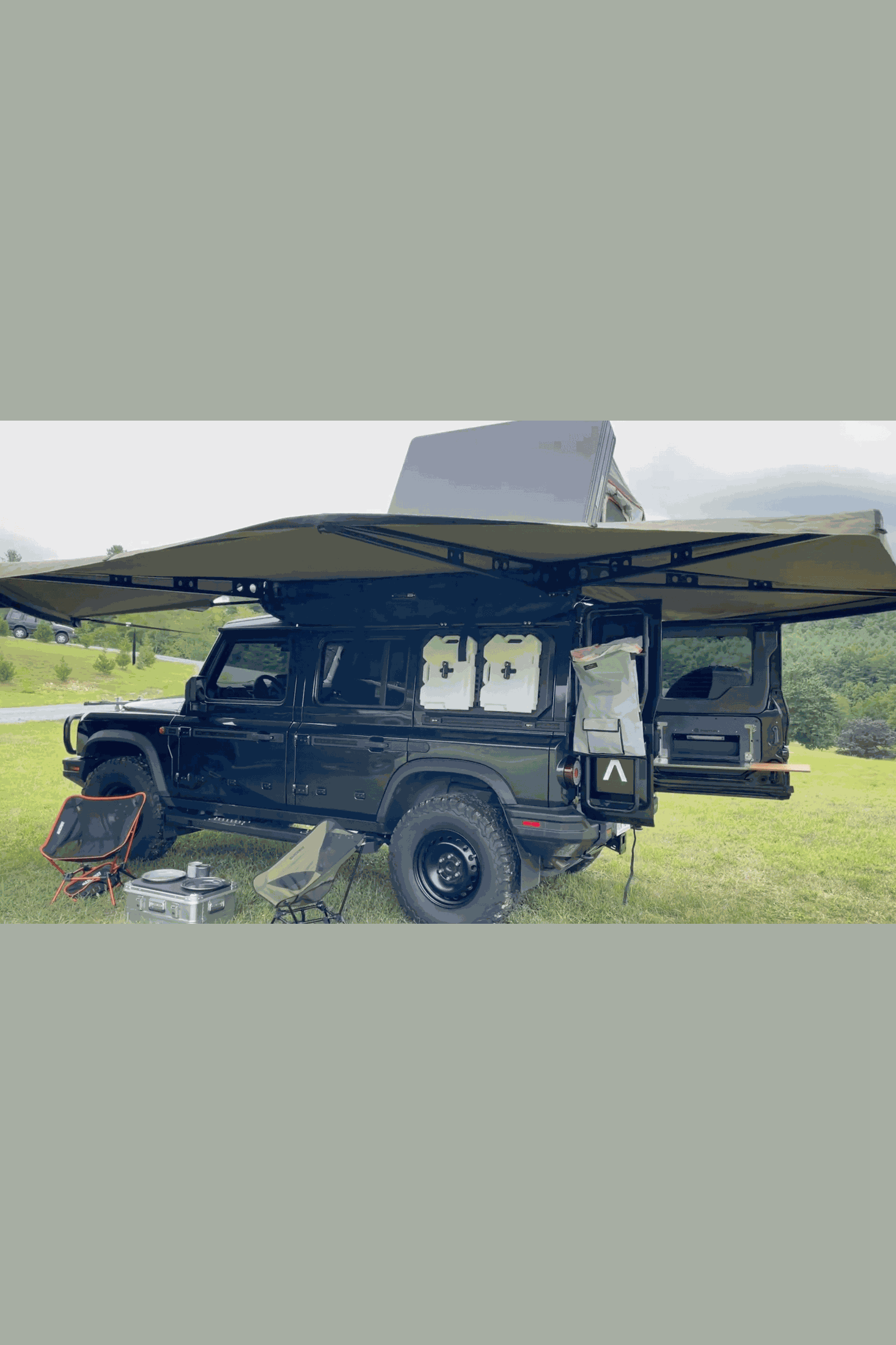 INEOS Grenadier Ladder Trash Bag attached to vehicle ladder, outdoor setting.