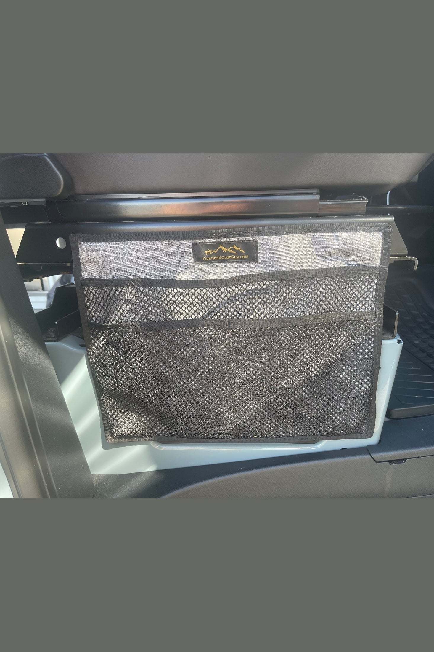XL magnetic seat base organizer pouch attached to vehicle seat base for storage and organization