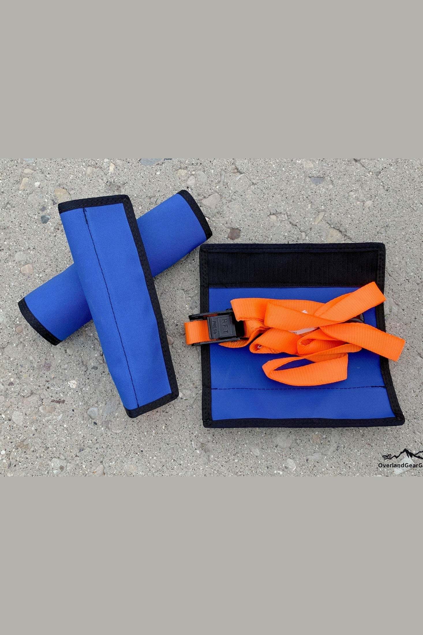 Blue tie down strap sleeves with orange strap for organized storage and easy access