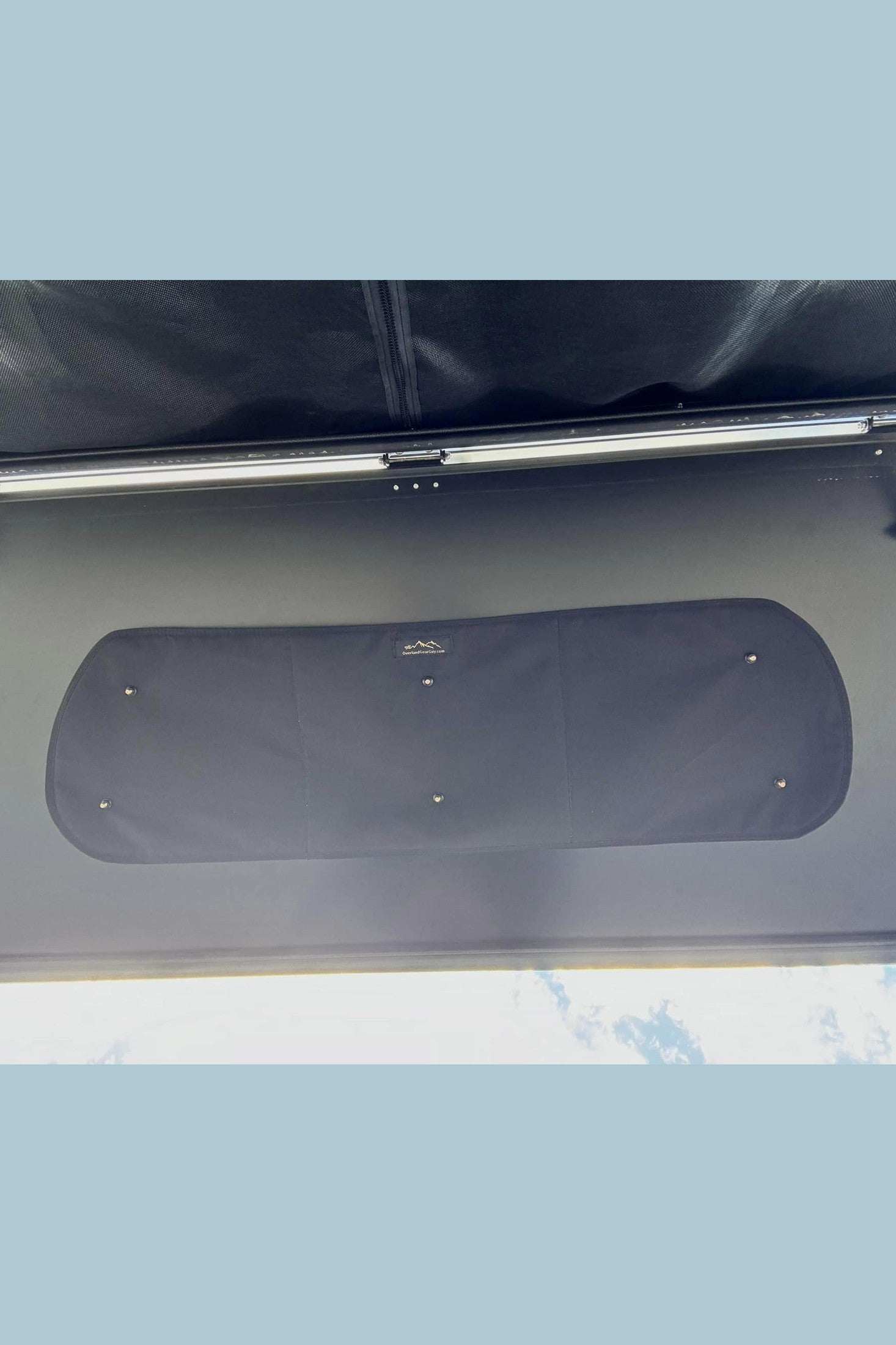 Topo Toppers insulated window cover installed on camper window with suction cups for temperature control and privacy