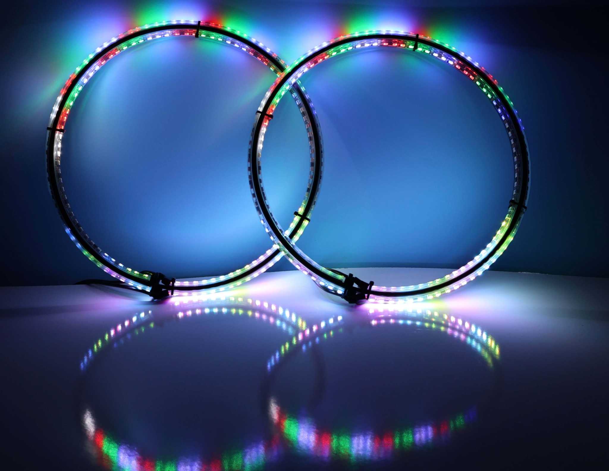 Apollo RGB wheel lights with harness included glowing in multiple colors with reflective light rings on surface