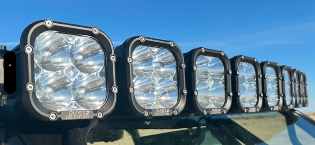 D2D PowerLink LED Light Bar mounted on off-road vehicle with multiple adjustable LED lights for rugged terrain illumination
