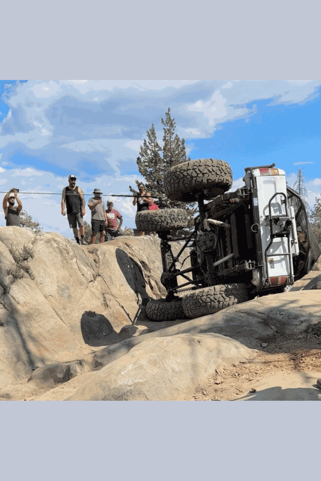 Off-road vehicle rolled over on rocky terrain during recovery using Hero Bridle.
