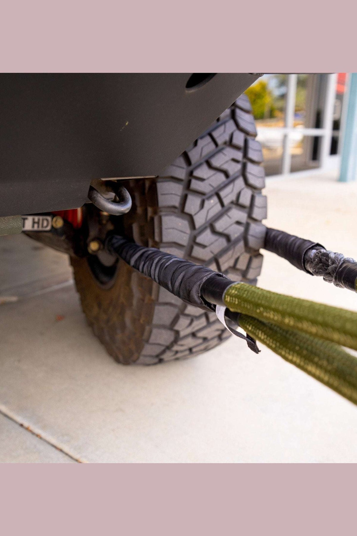 Hero Bridle attached to off-road vehicle tire, demonstrating metal-edge rated recovery and extension capabilities.