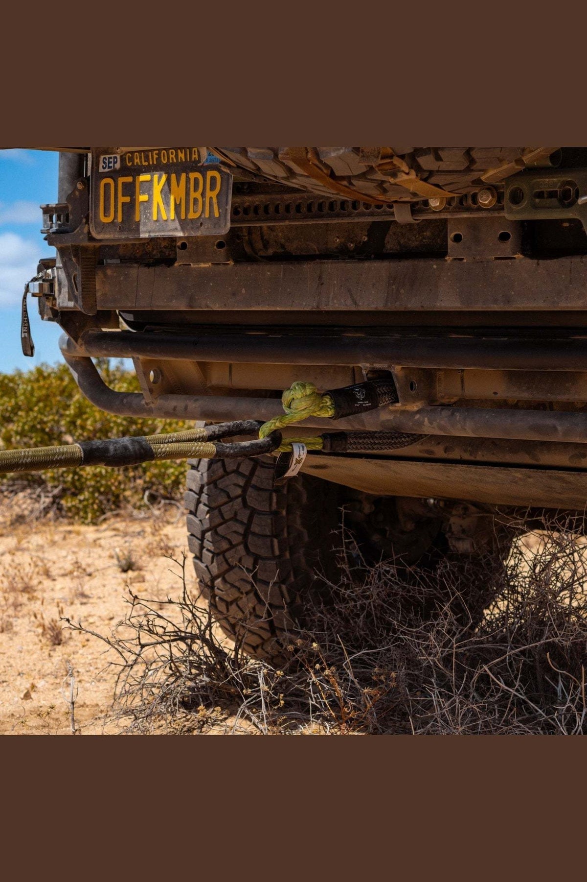 Heavy-duty off-road vehicle using Hitch Hero Soft Shackle for towing in desert terrain.