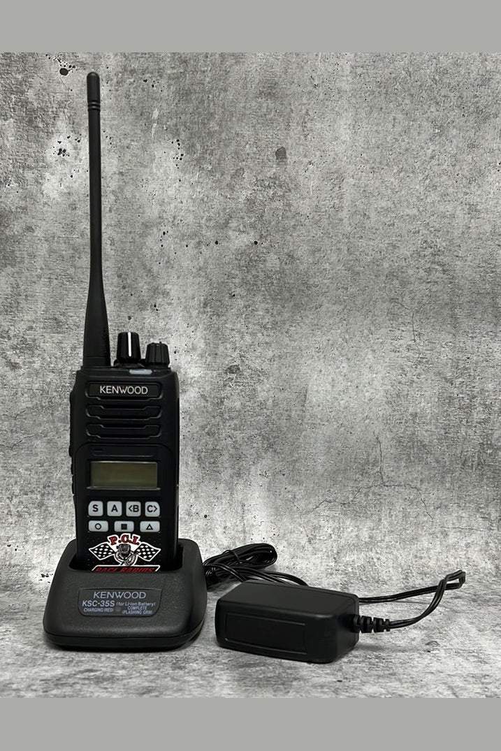 Kenwood NX-1300 handheld UHF radio with charger on gray background clearance sale