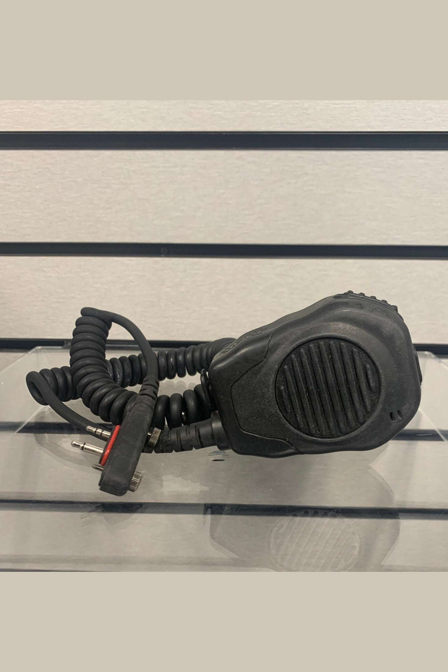 Compact black Icom speaker mic with coiled cord and 3.5mm earpiece port, IP56 waterproof compliant and swivel clothing clip