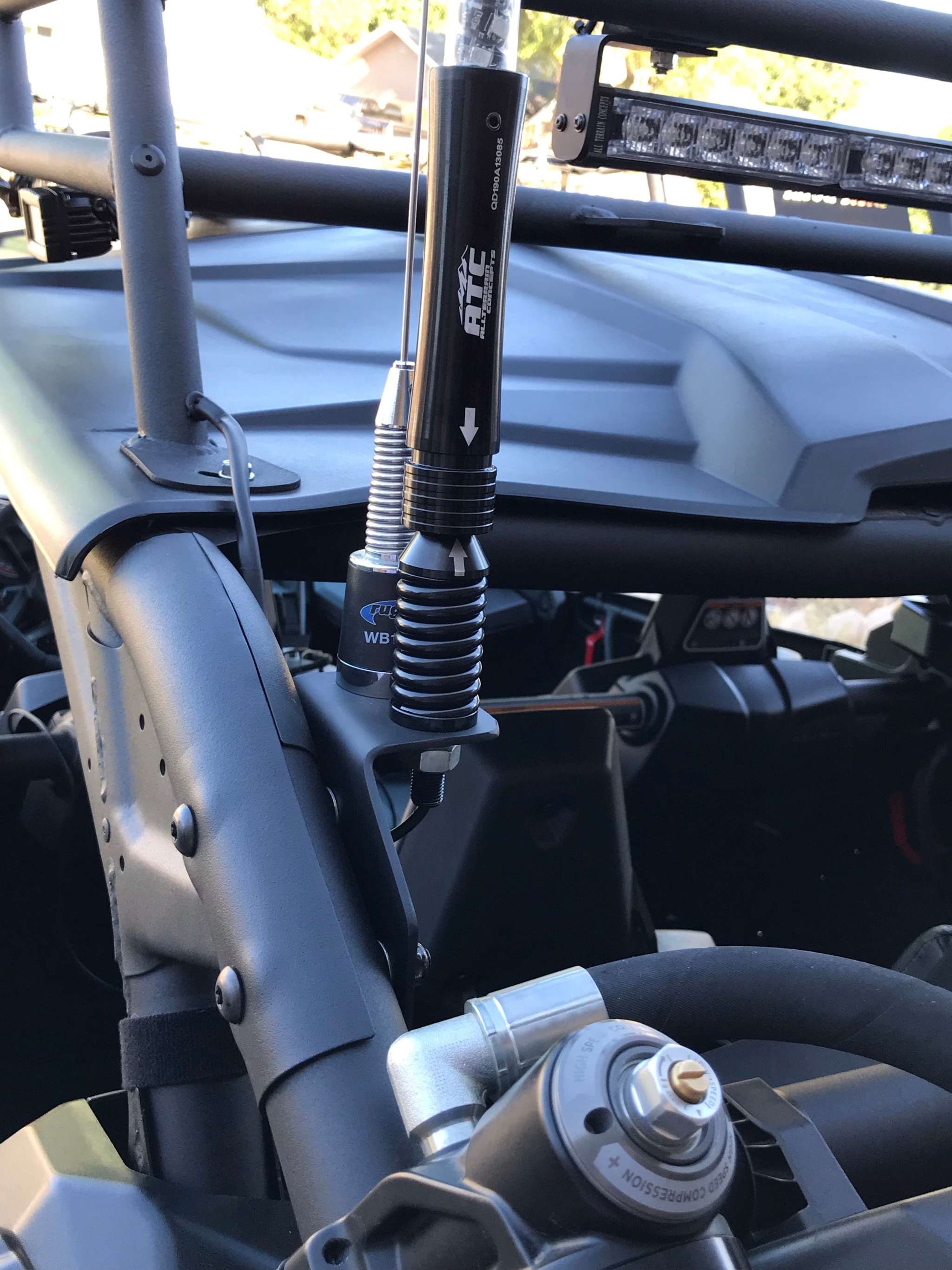 Can-Am Whip Mount installed on roll bar with antenna attached, made of durable steel with powder coat finish