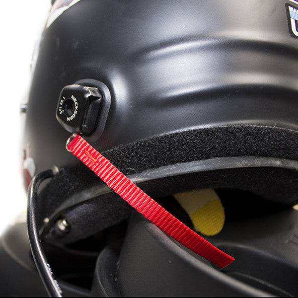 Technician performing HNR installation on helmet for desert safety