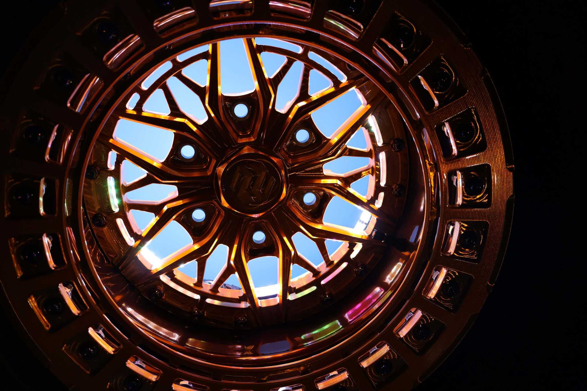 Apollo RGB wheel lights installed on a car rim with vibrant multicolor glow and harness included