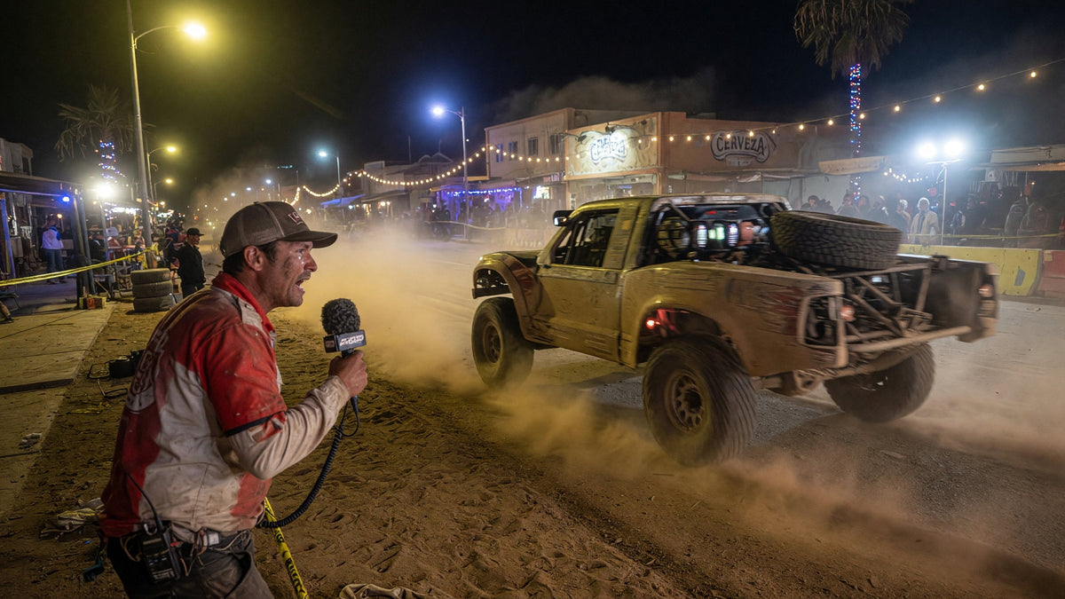 Trophy truck in Ensenada dust after the SCORE Baja 400, chase crew on the highway at dusk